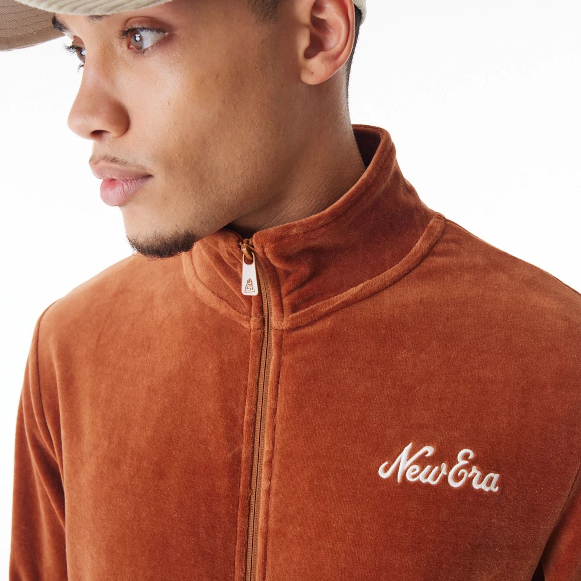 The Male model is wearing  New Era Velour Brown Track Jacket  7