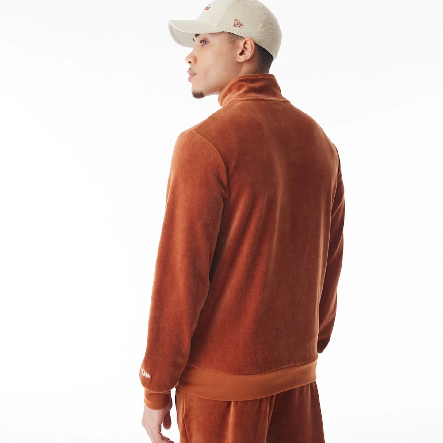 The Male model is wearing  New Era Velour Brown Track Jacket  10