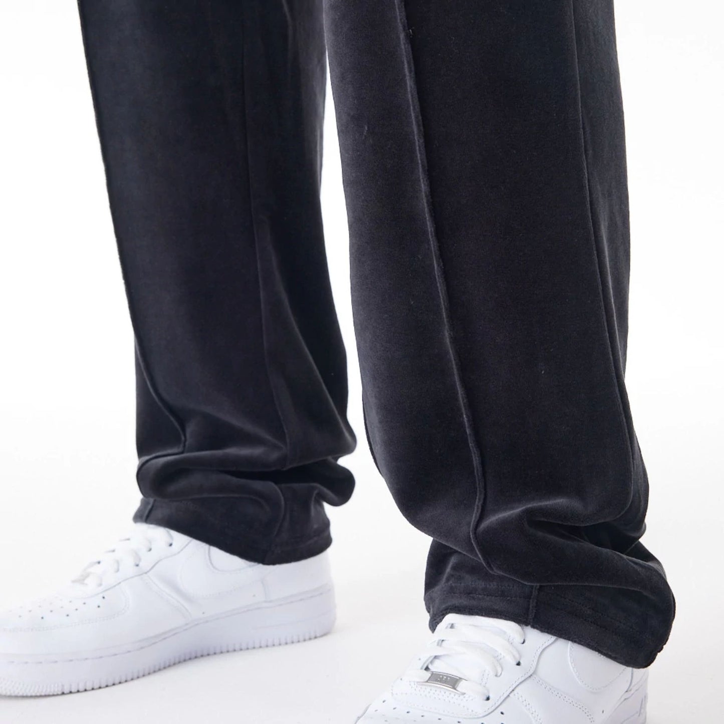 The Male model is wearing  New Era Velour Black Track Joggers  3