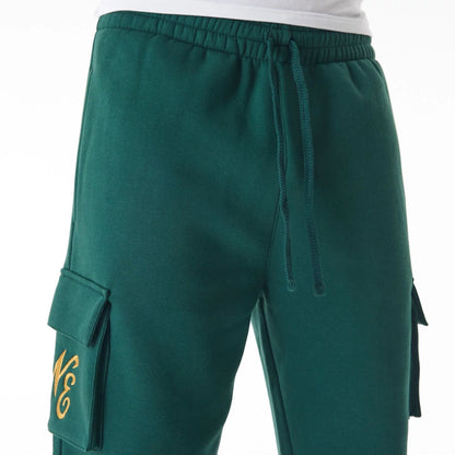 The Male model is wearing  New Era Script Cargo Dark Green Joggers  7