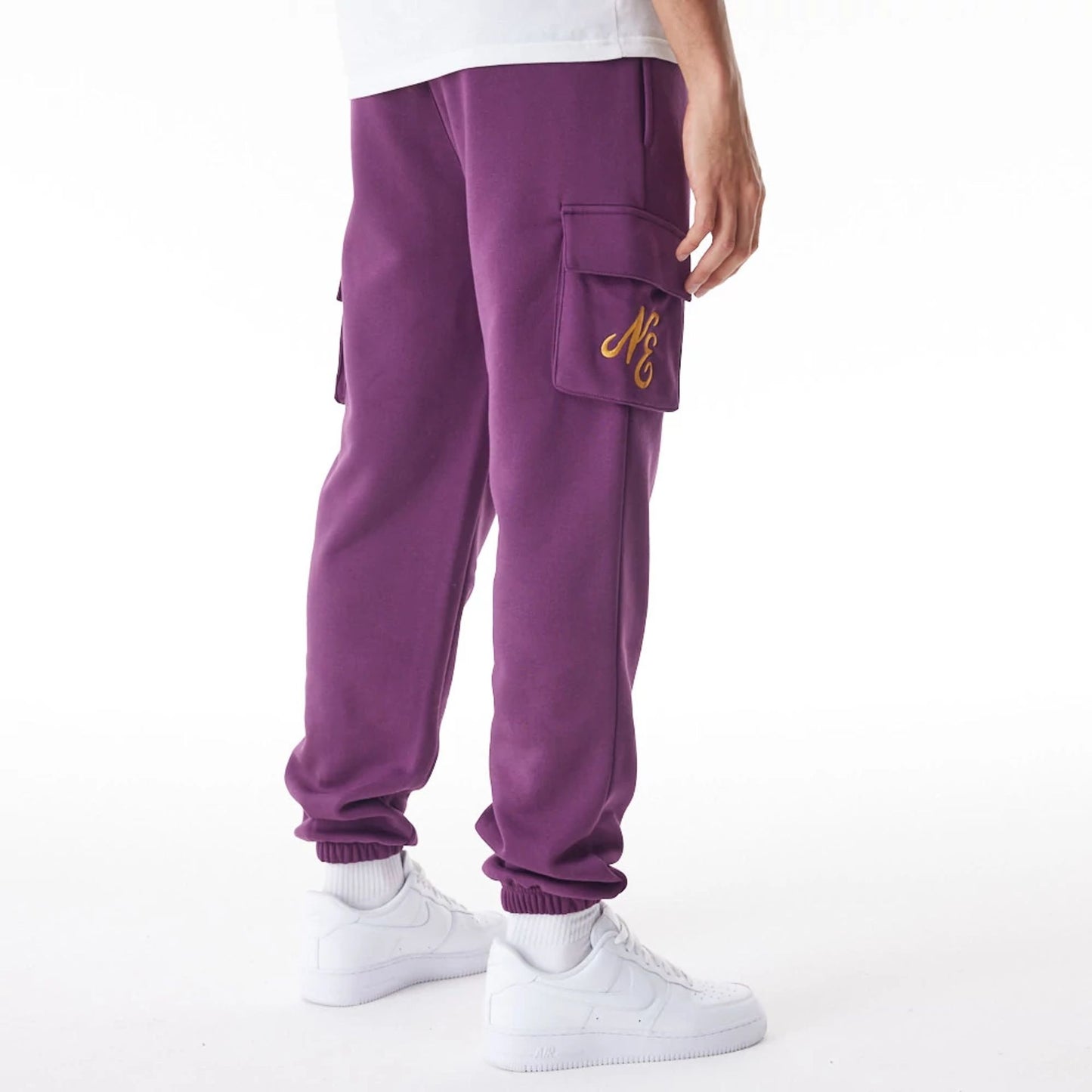 The Male model is wearing  New Era Script Cargo Dark Purple Joggers  6