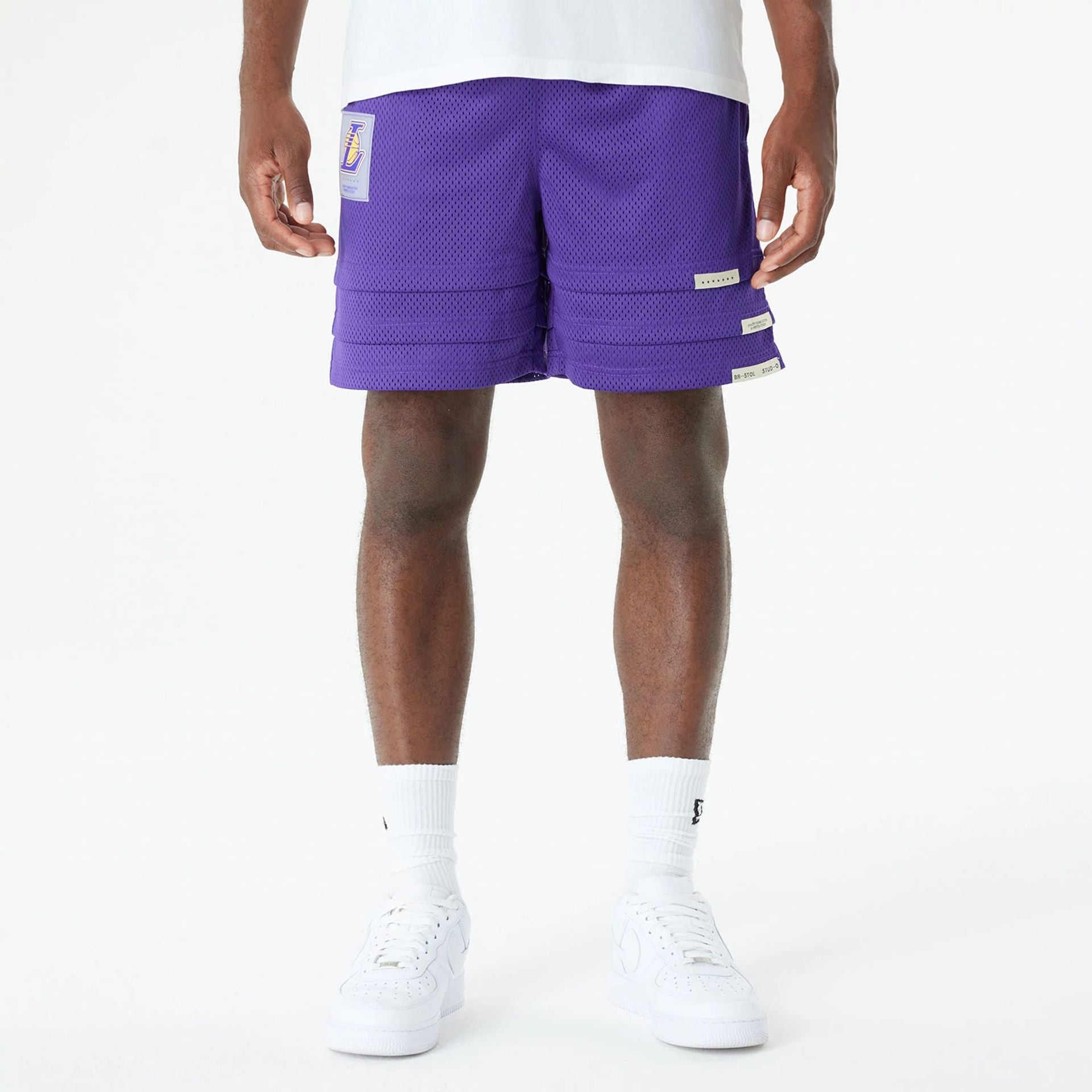 The Male model is wearing LA Lakers Bristol Studio x NBA Purple Shorts 1