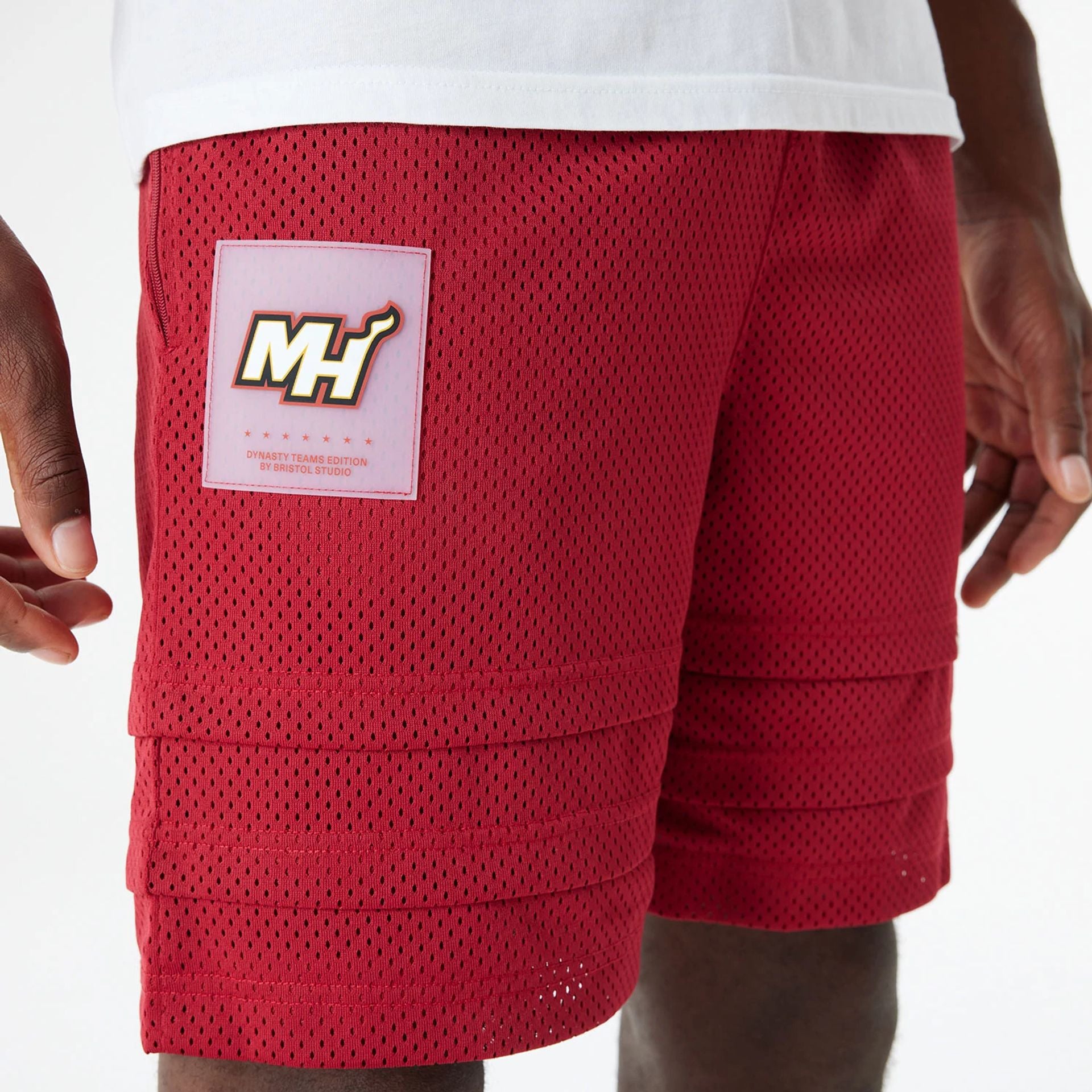 The Male model is wearing Miami Heat Bristol Studio x NBA Dark Red Shorts 3