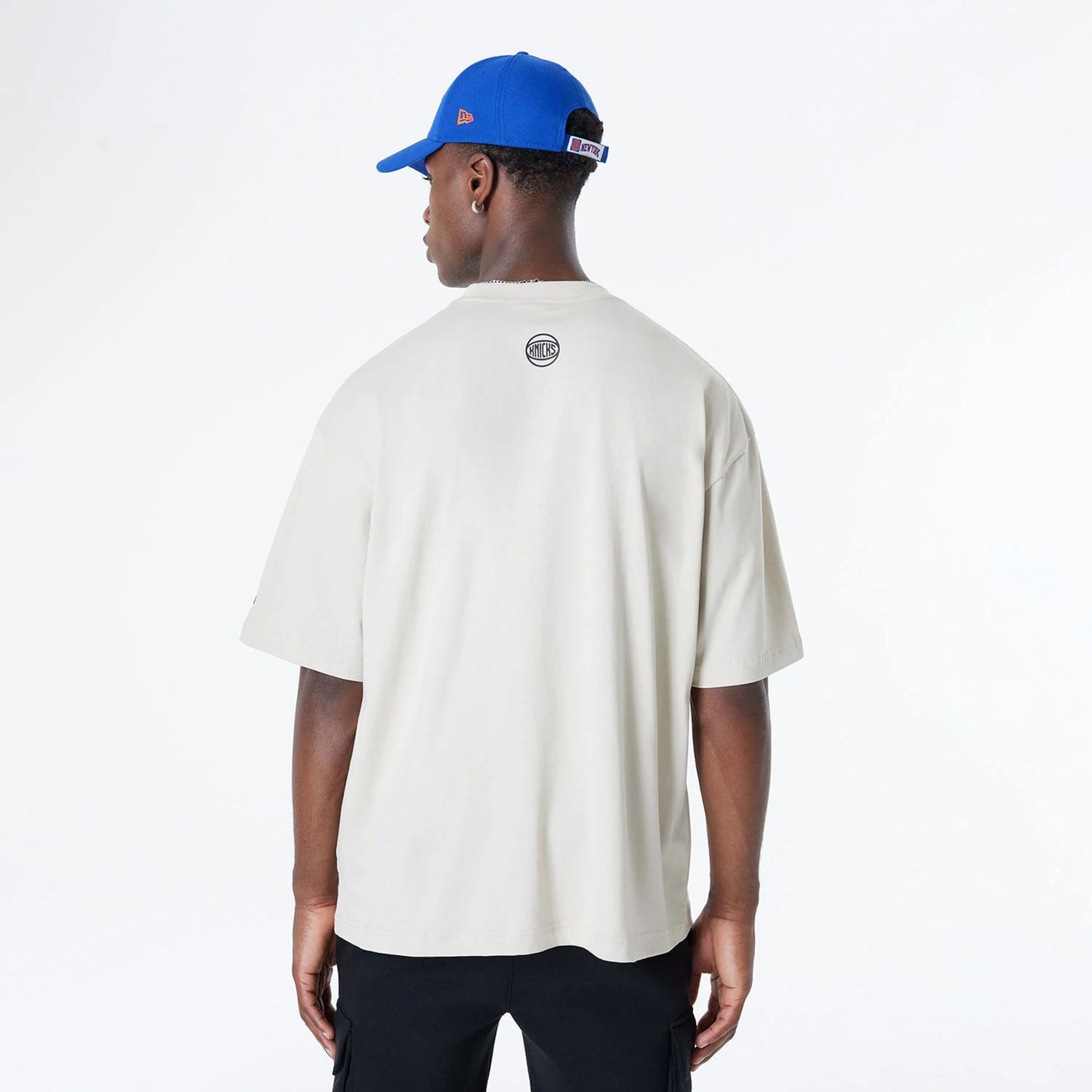 The Male model is wearing New York Knicks Bristol Studio x NBA Light Beige Oversized T-Shirt 2