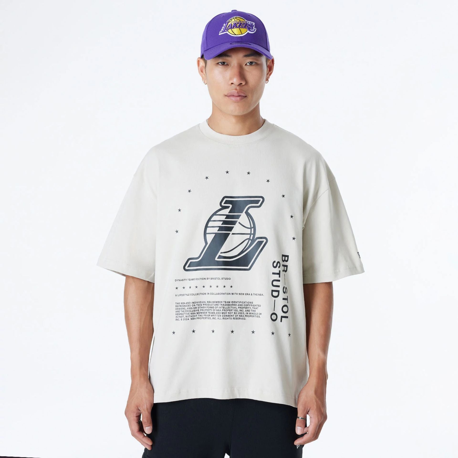 The Male model is wearing LA Lakers Bristol Studio x NBA Light Beige Oversized T-Shirt 1