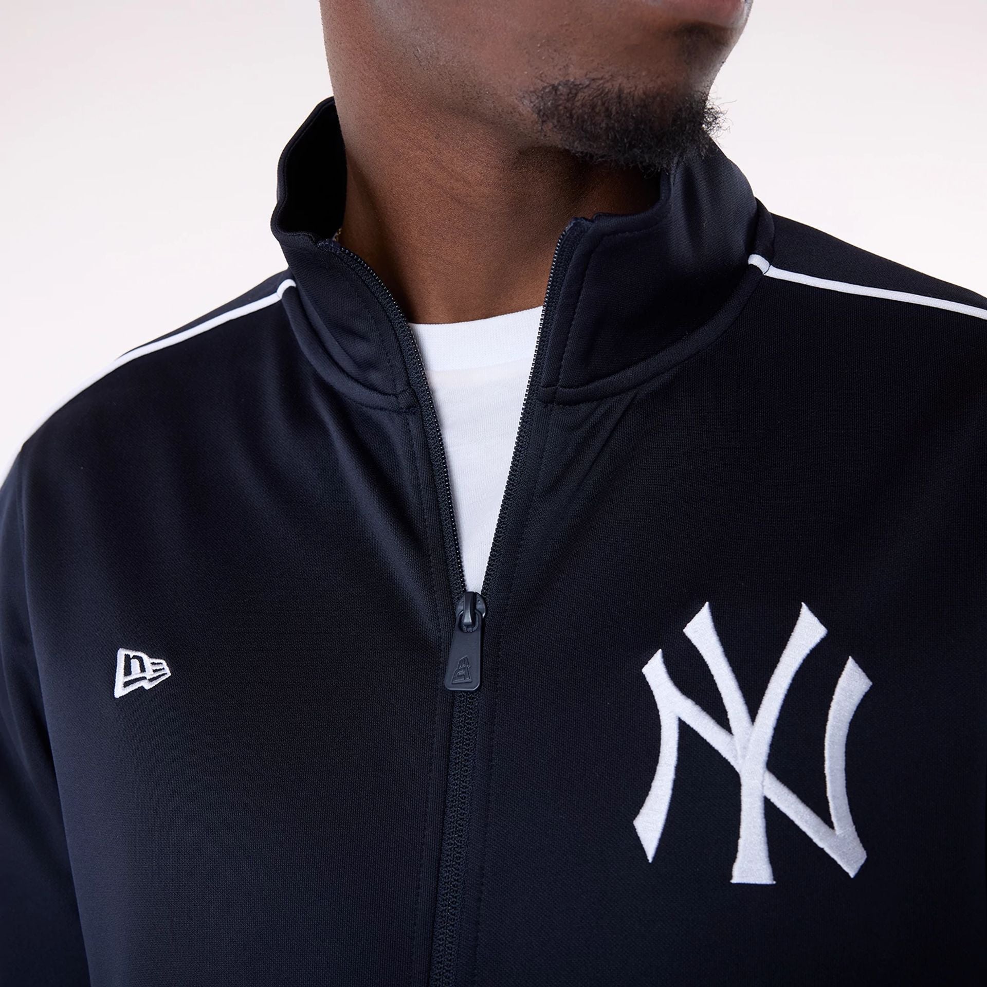 The Male model is wearing New York Yankees MLB Track Top Navy Track Jacket 5