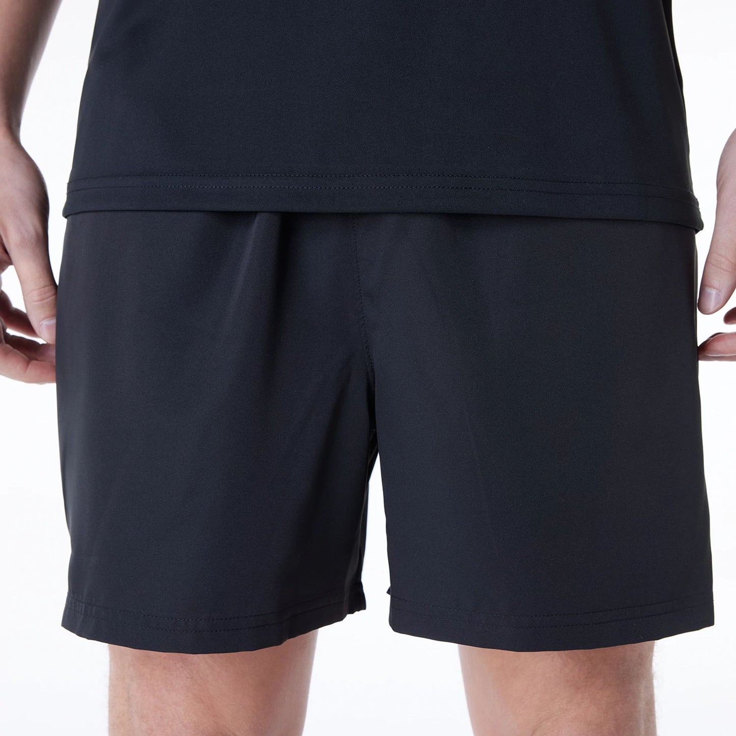 The Male model is wearing New Era Essential Black Shorts 2