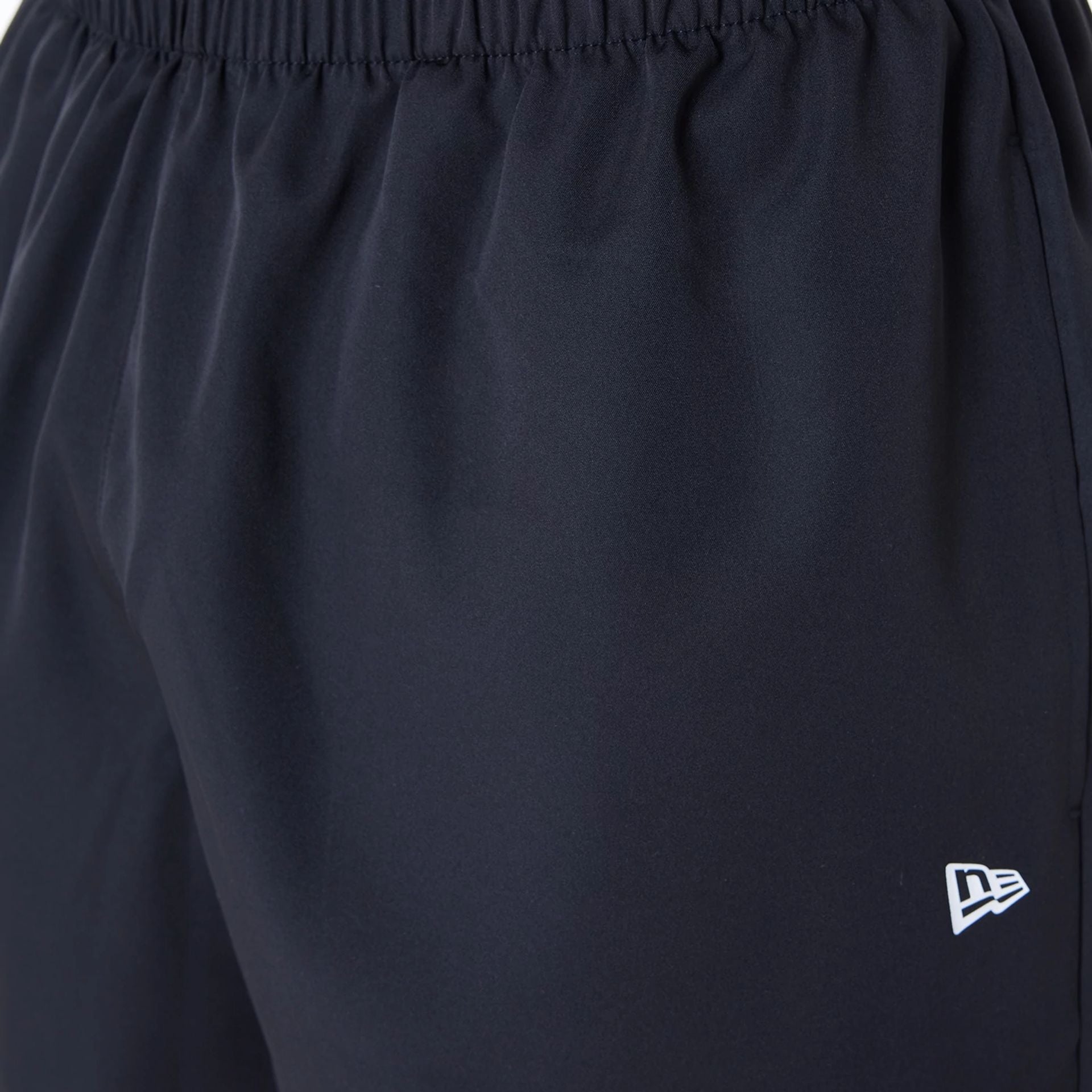 The Male model is wearing New Era Essential Black Shorts 4