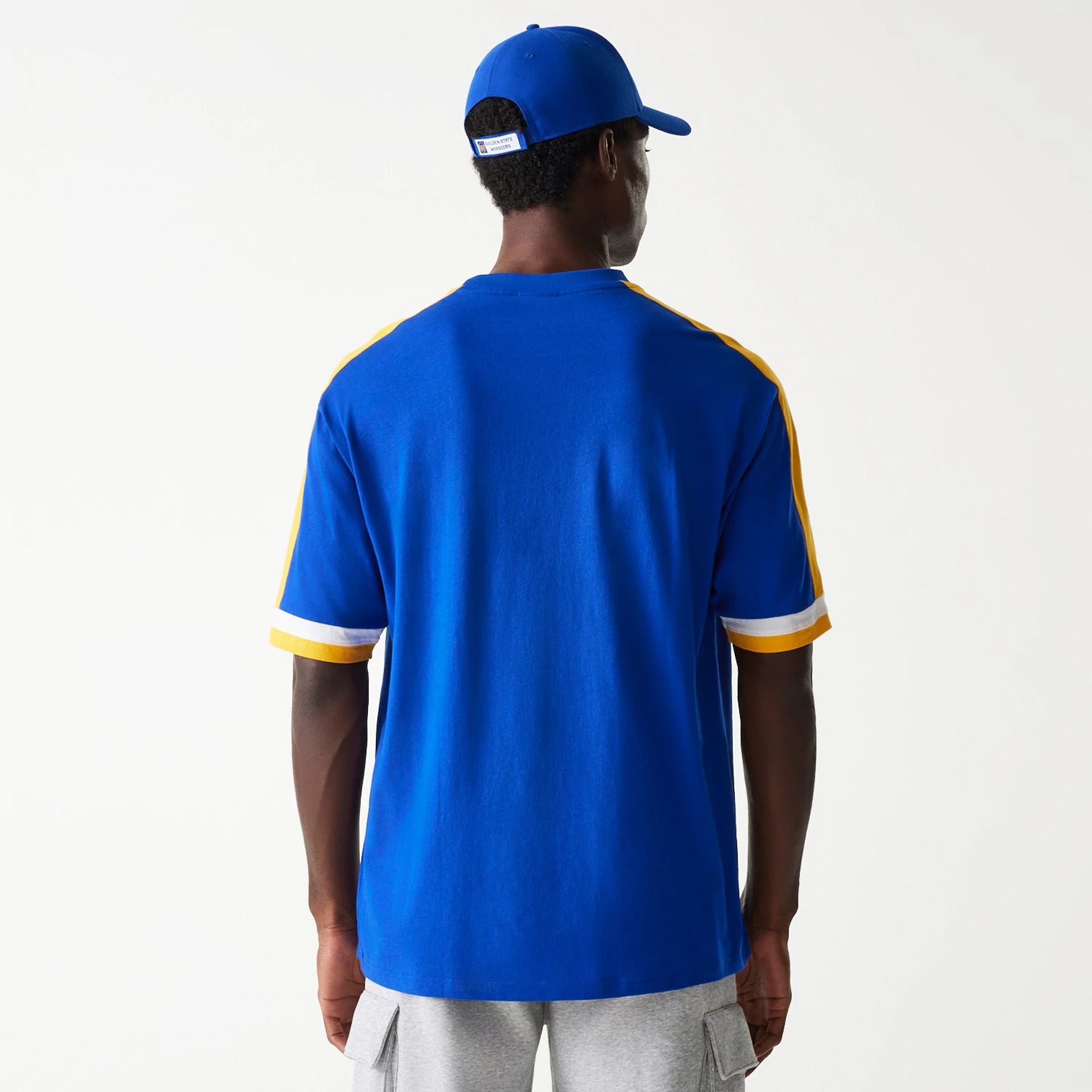 The Male model is wearing Golden State Warriors NBA Panel Blue Oversized T-Shirt 2