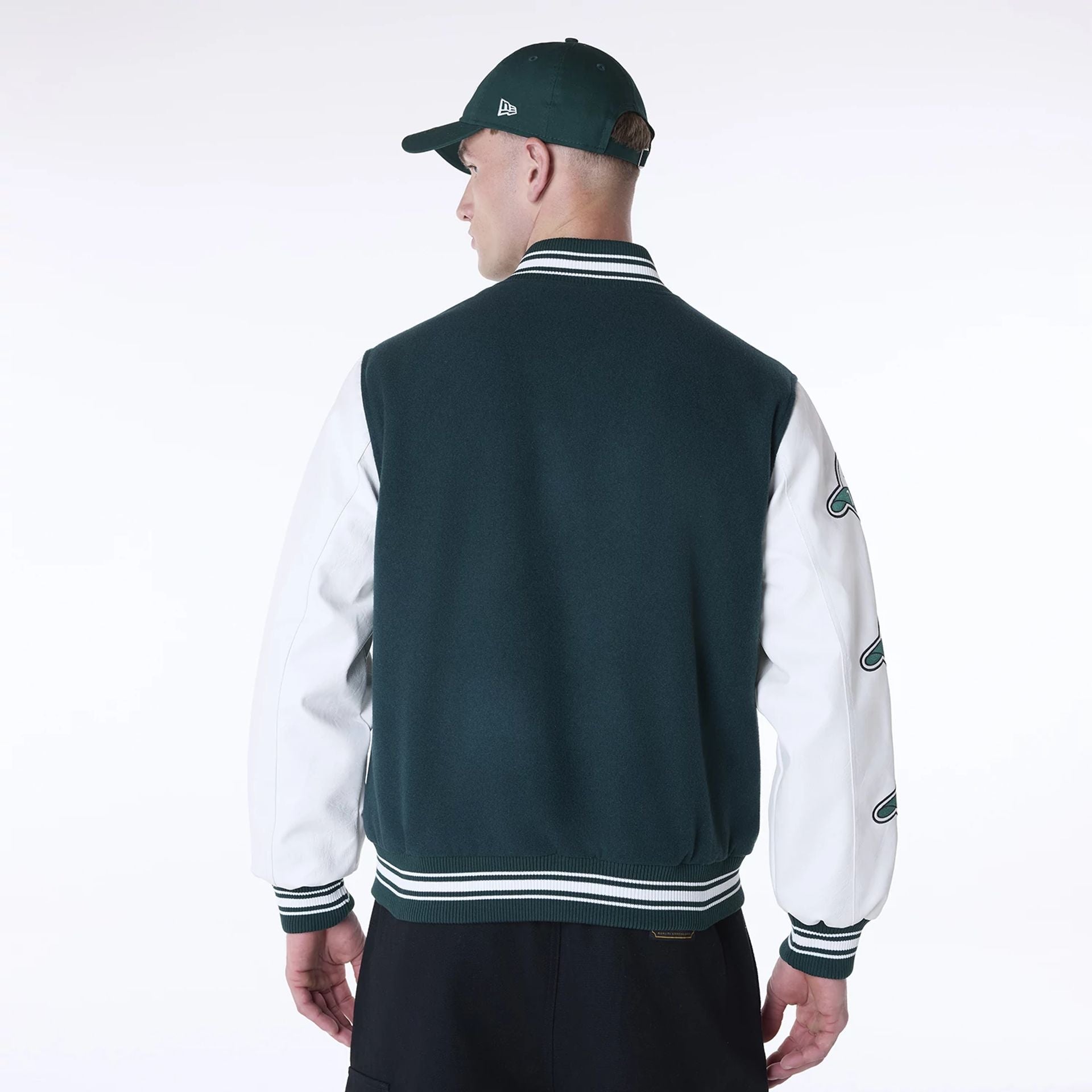 The Male model is wearing New Era Patch Dark Green Varsity Jacket 2