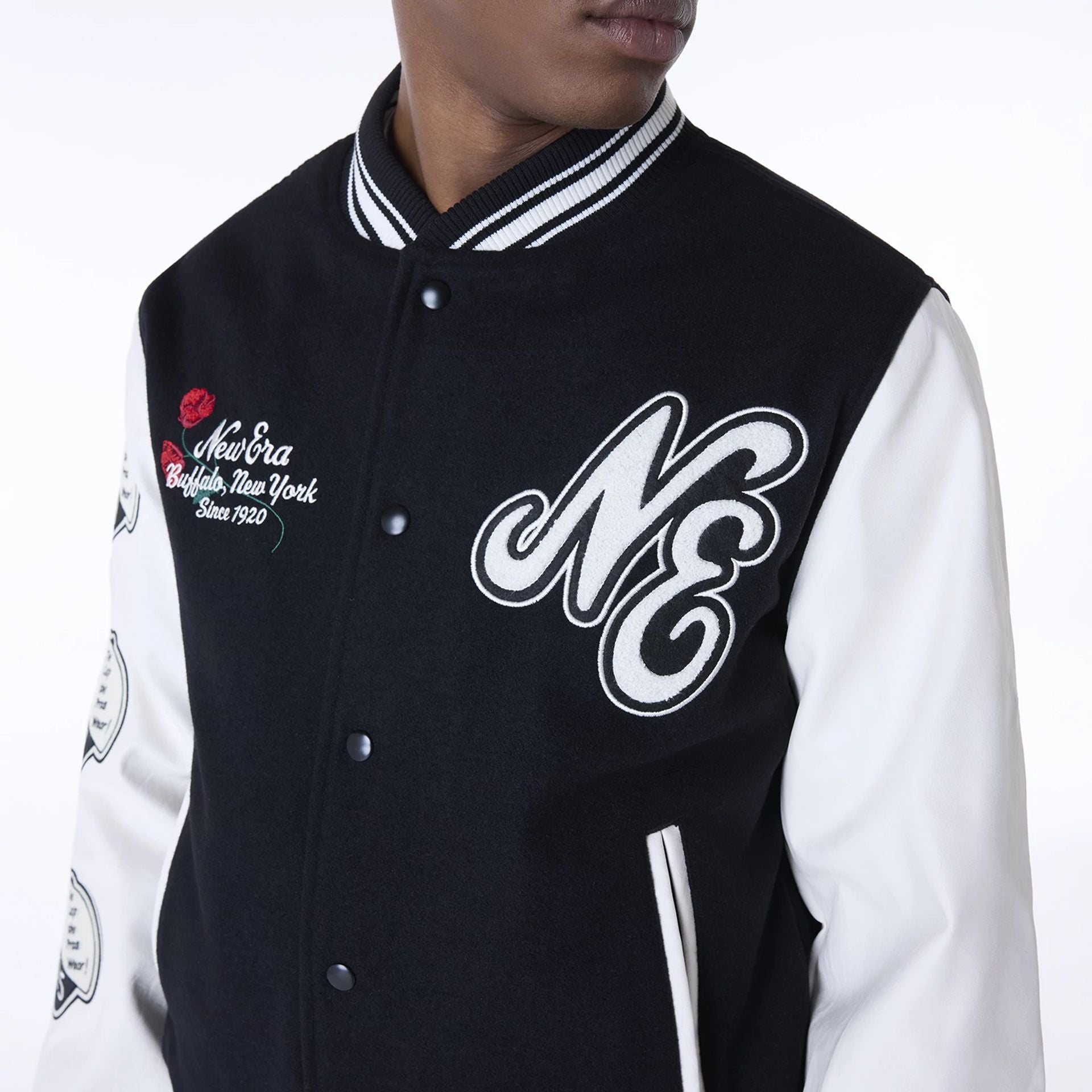 The Male model is wearing New Era Essential Black Varsity Jacket 5