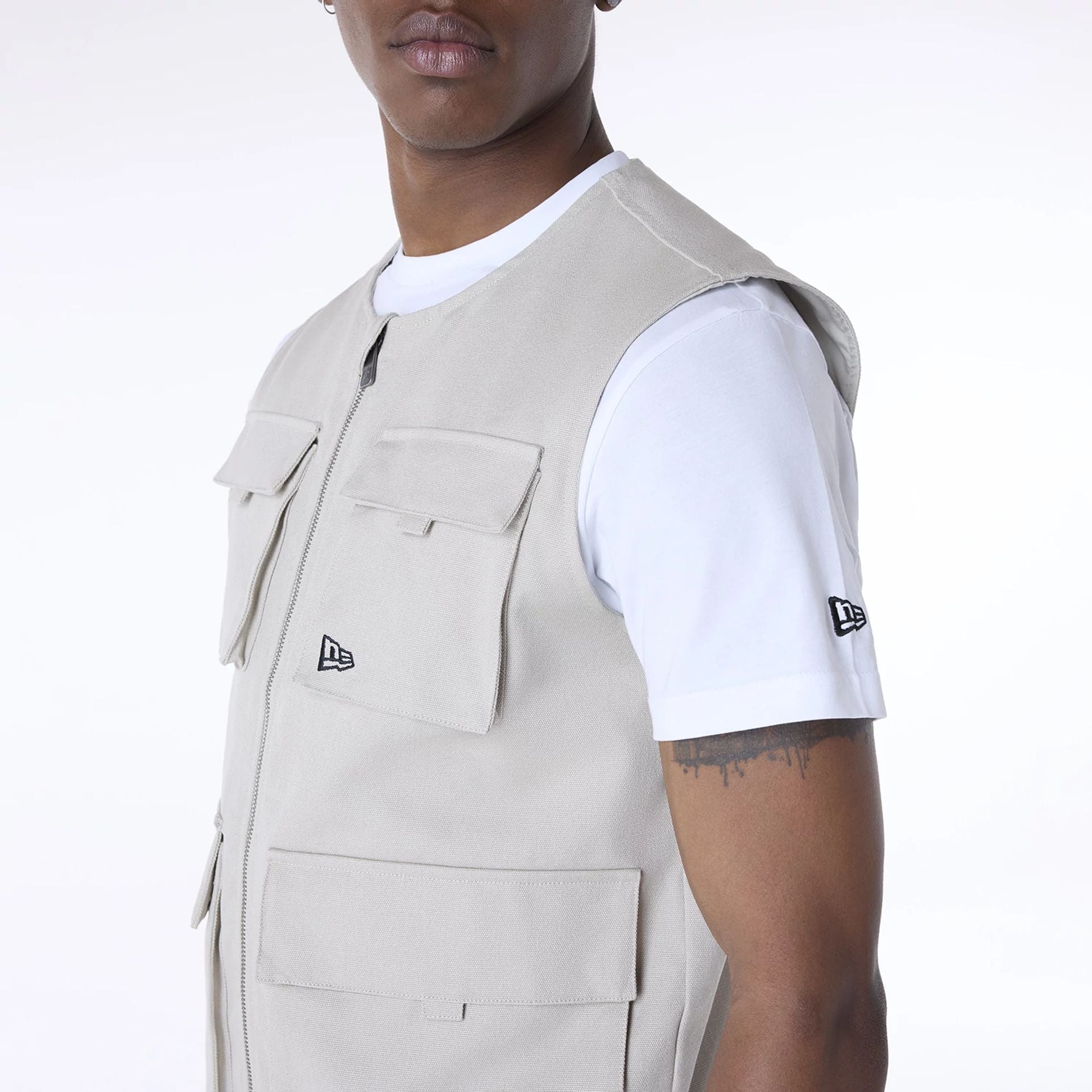 The Male model is wearing New Era Essential Cream Utility Vest 3