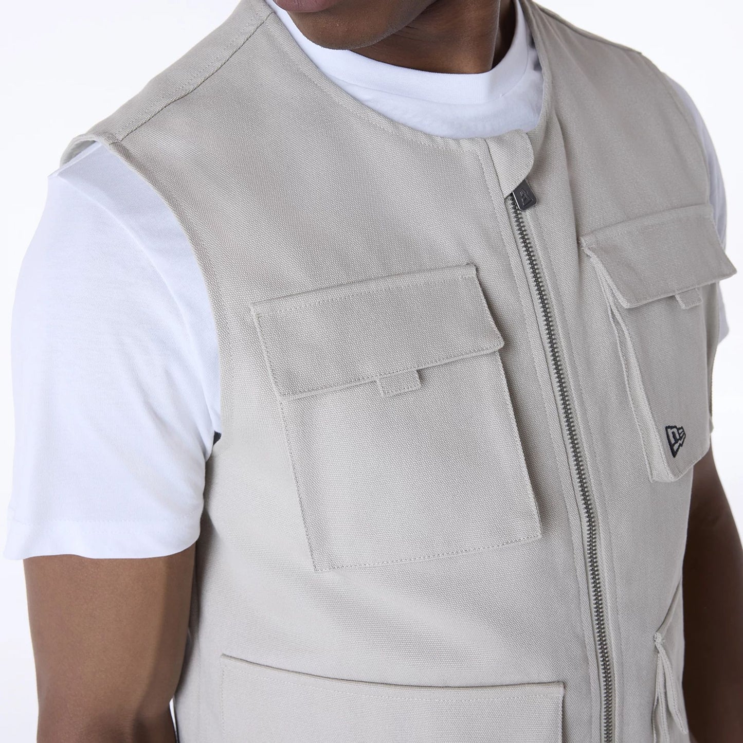 The Male model is wearing New Era Essential Cream Utility Vest 5