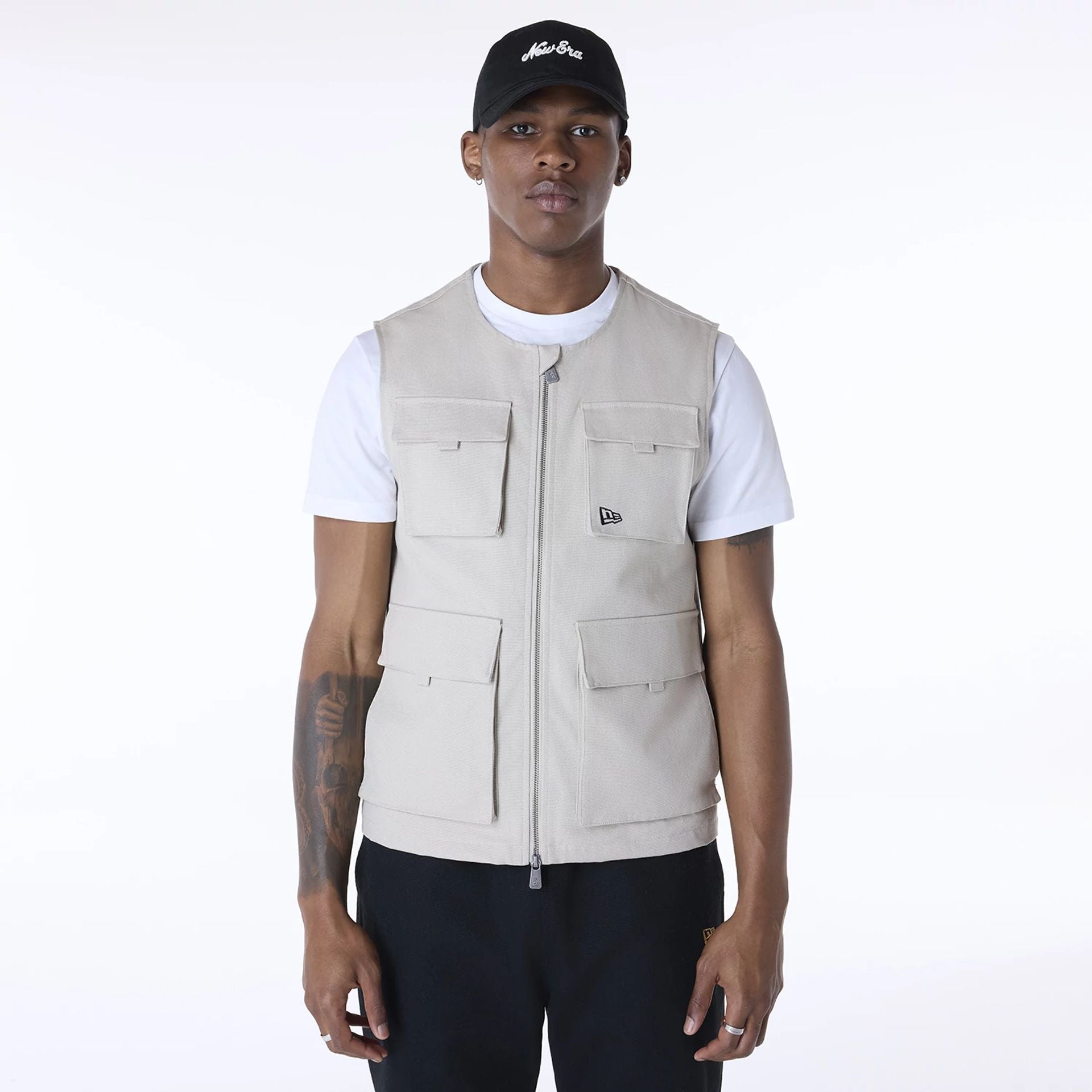 The Male model is wearing New Era Essential Cream Utility Vest 1