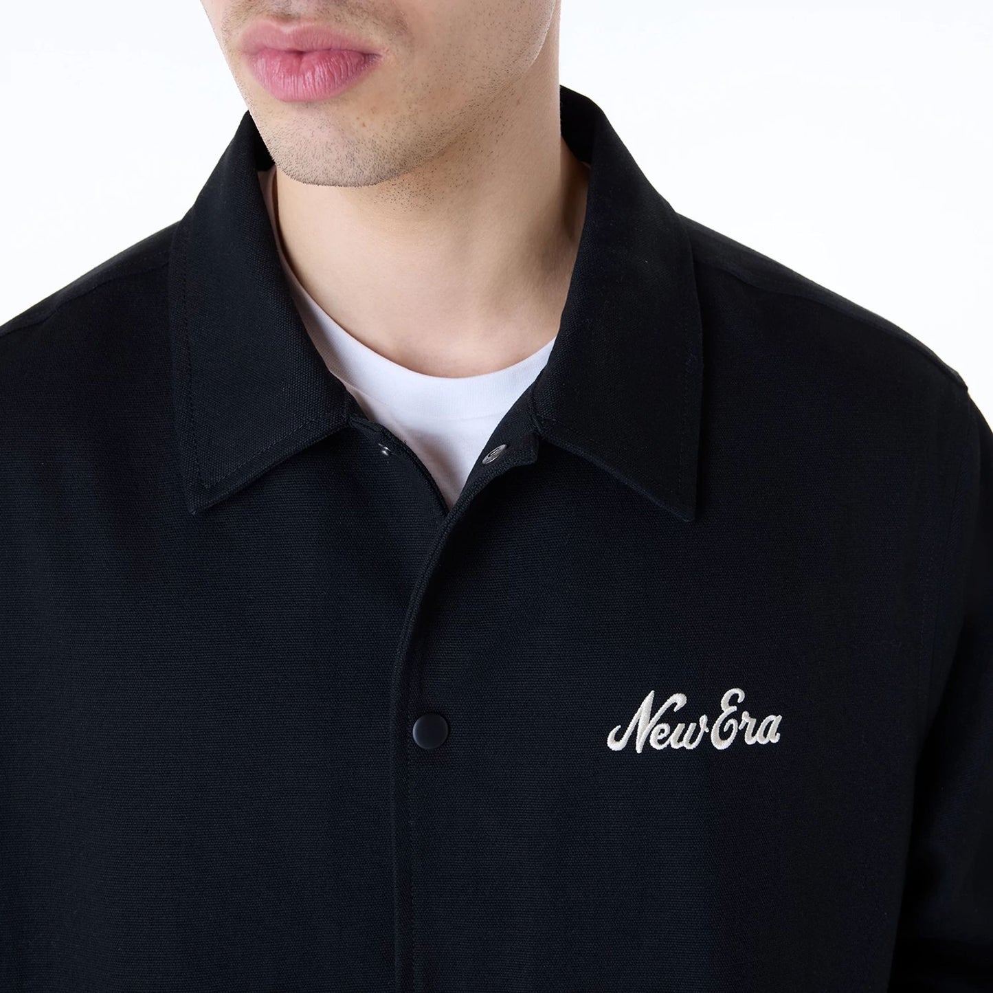 The Male model is wearing New Era Essential Black Coaches Jacket 7