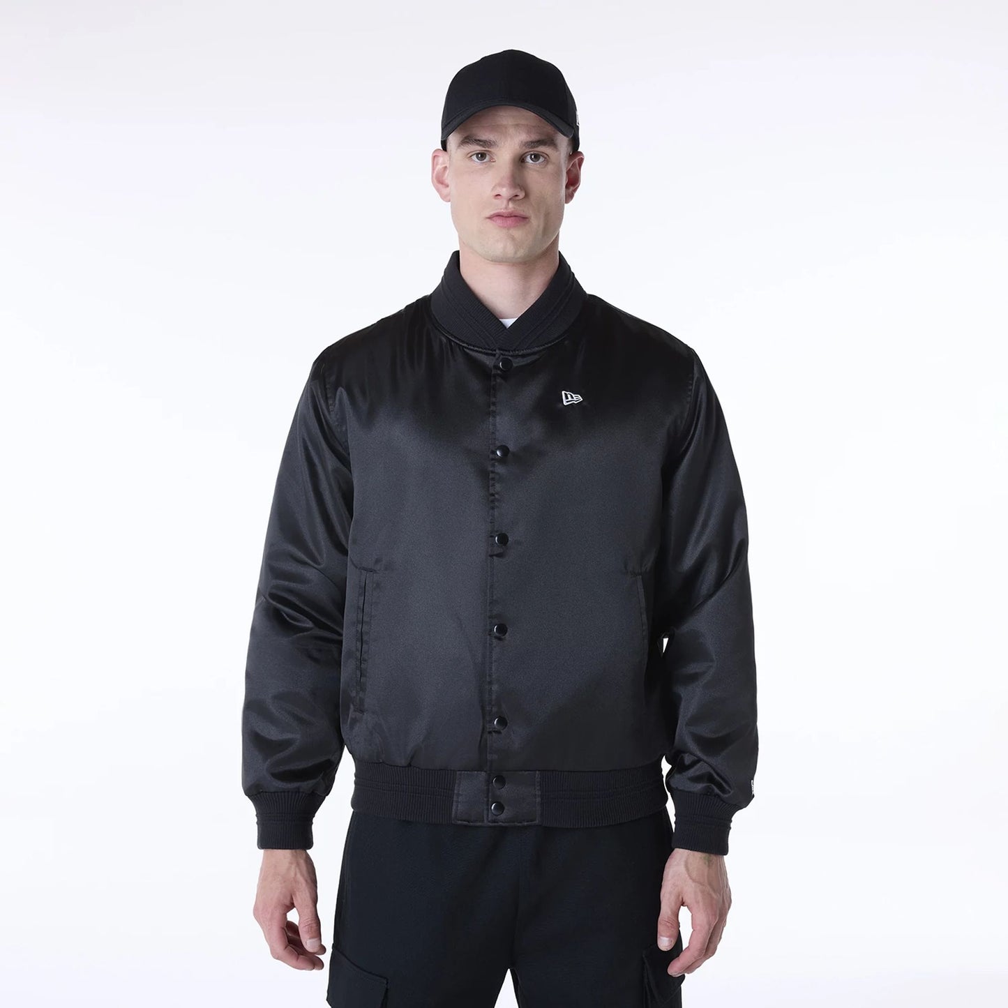 The Male model is wearing New Era Essential Black Satin Bomber Jacket 1