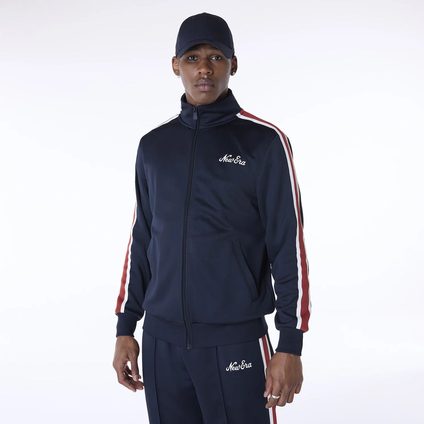 The Male model is wearing New Era Essential Navy Track Jacket 1