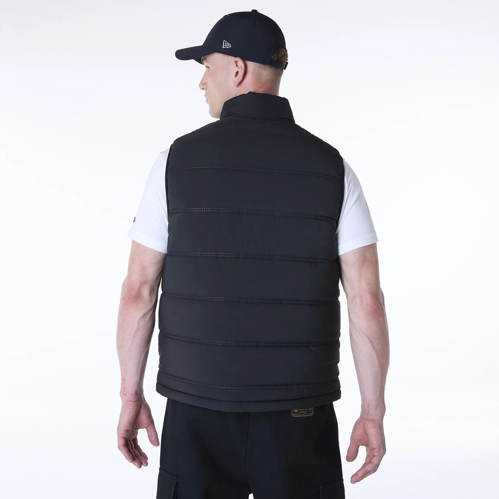 The Male model is wearing New Era Essential Black Padded Gilet 2