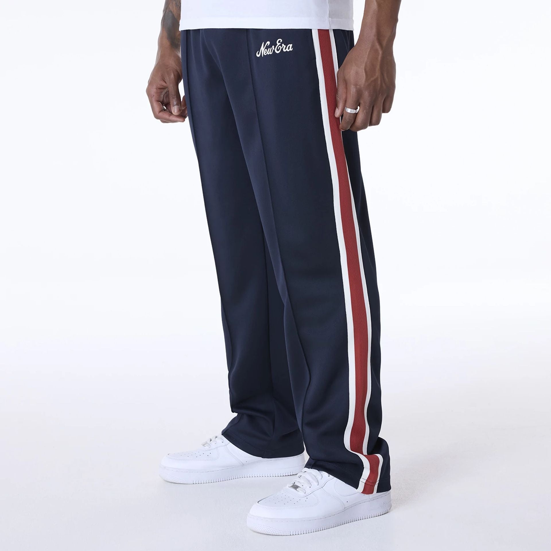 The Male model is wearing New Era Essential Navy Track Pants 6