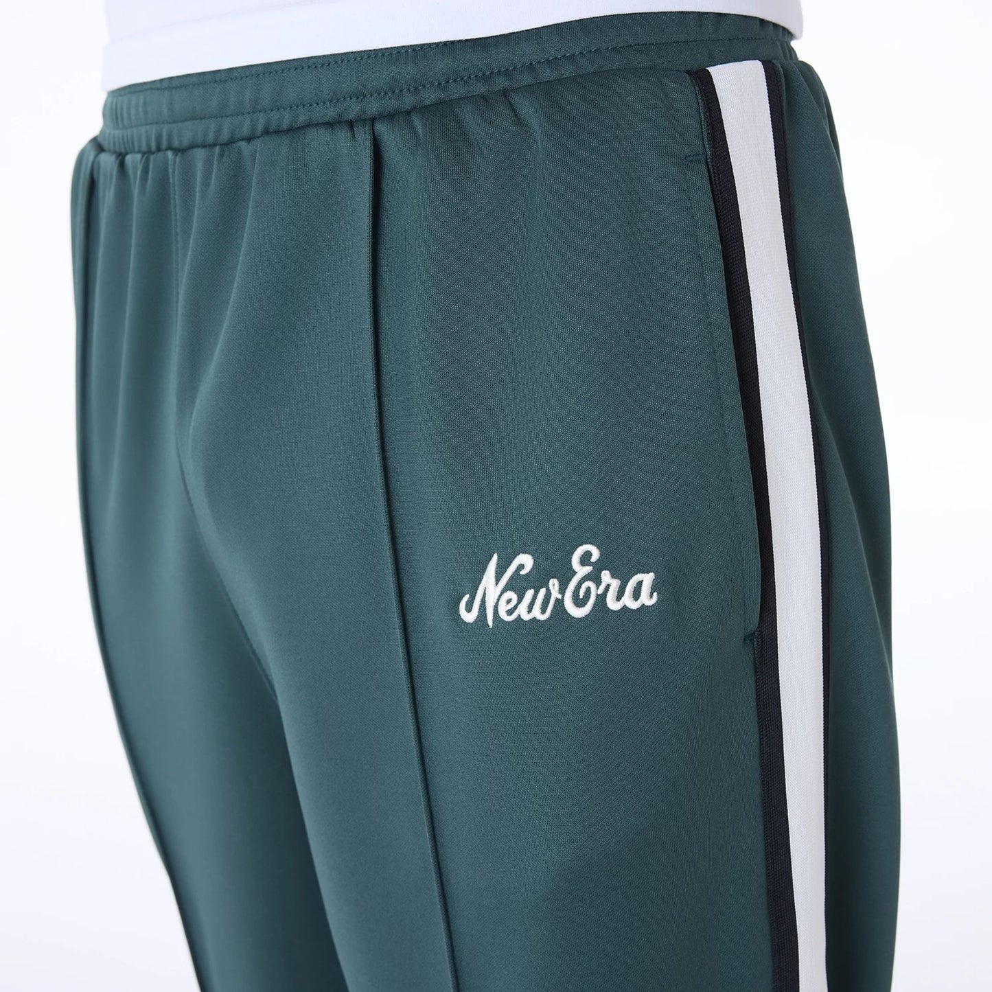 The Male model is wearing New Era Essential Dark Green Track Pants 5