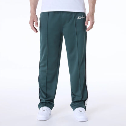 The Male model is wearing New Era Essential Dark Green Track Pants 1