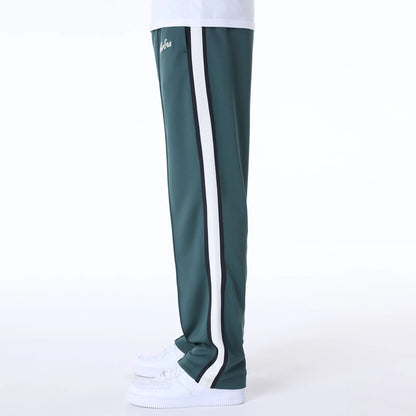 The Male model is wearing New Era Essential Dark Green Track Pants 4