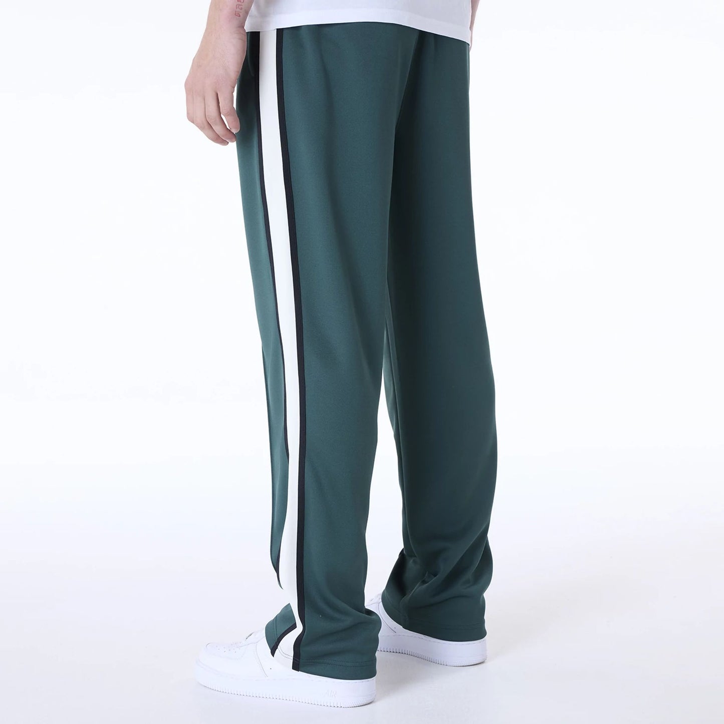 The Male model is wearing New Era Essential Dark Green Track Pants 2