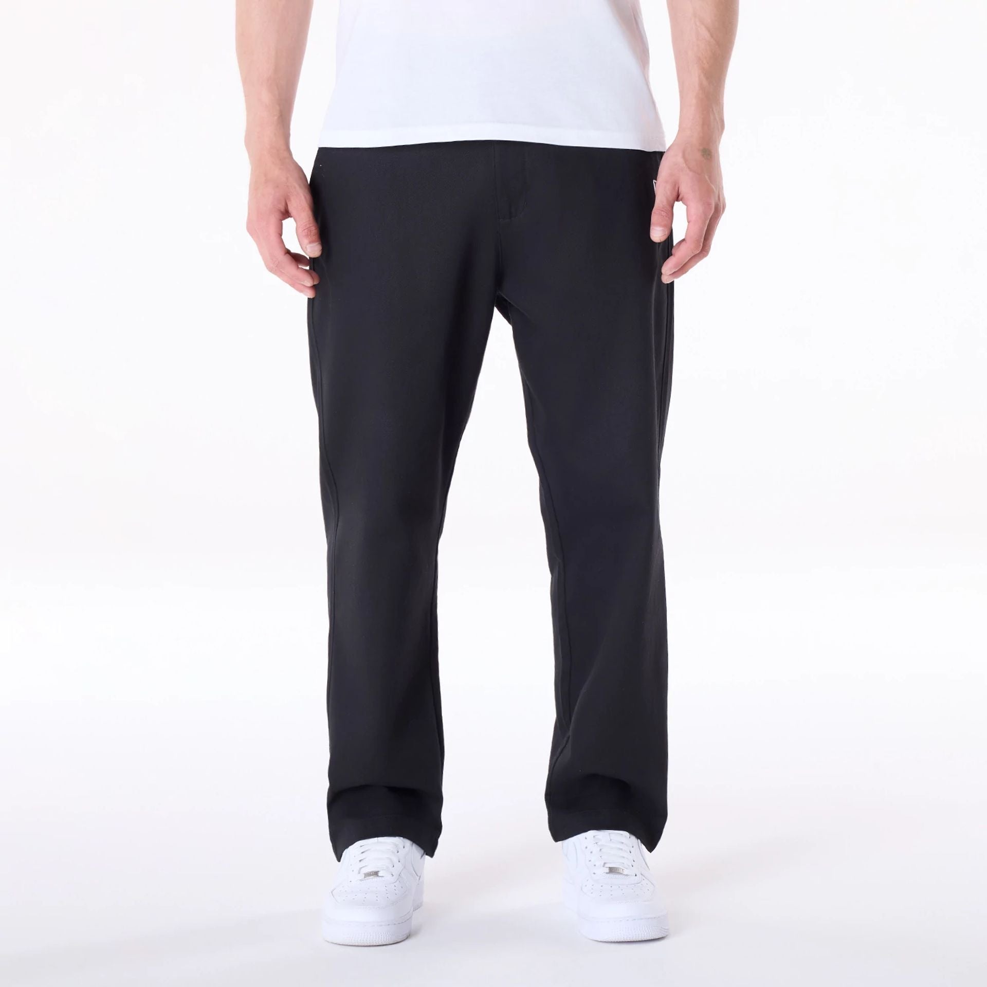 The Male model is wearing New Era Black Chino Trousers 1