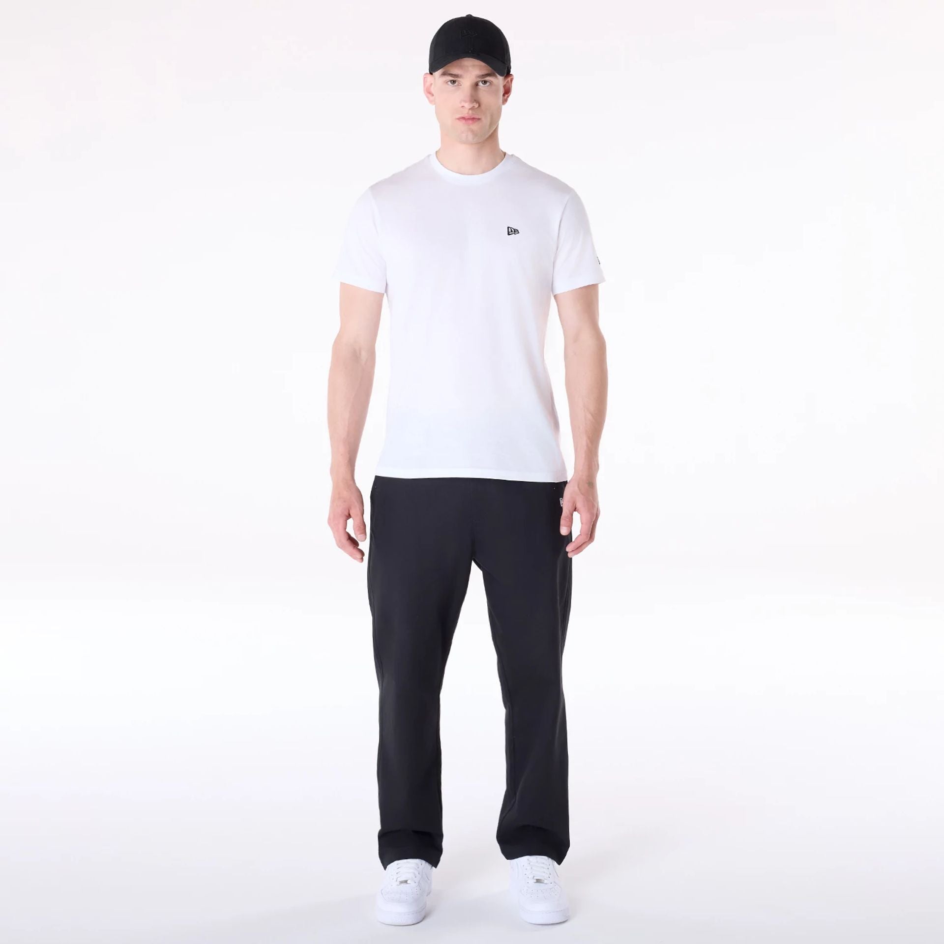 The Male model is wearing New Era Black Chino Trousers 4