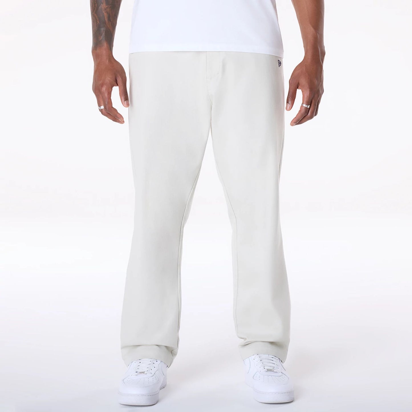 The Male model is wearing New Era Cream Chino Trousers 1