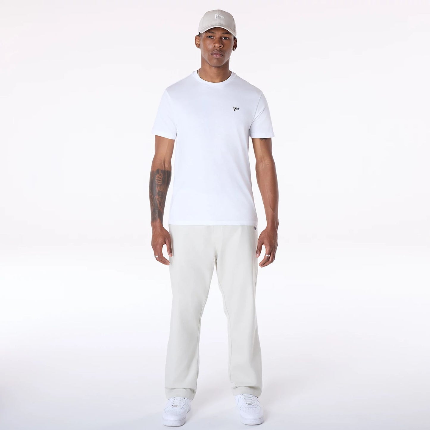 The Male model is wearing New Era Cream Chino Trousers 4