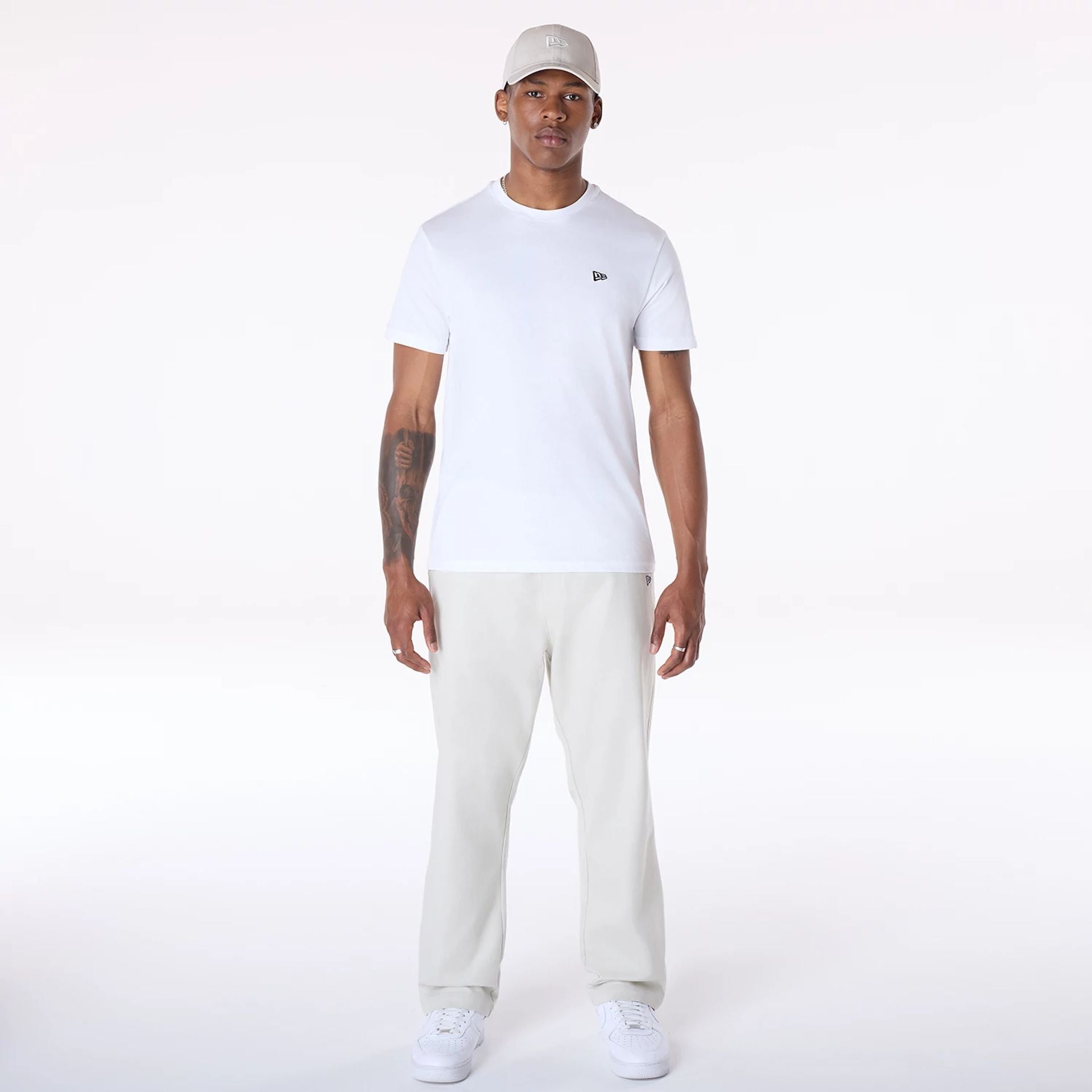 The Male model is wearing New Era Cream Chino Trousers 4