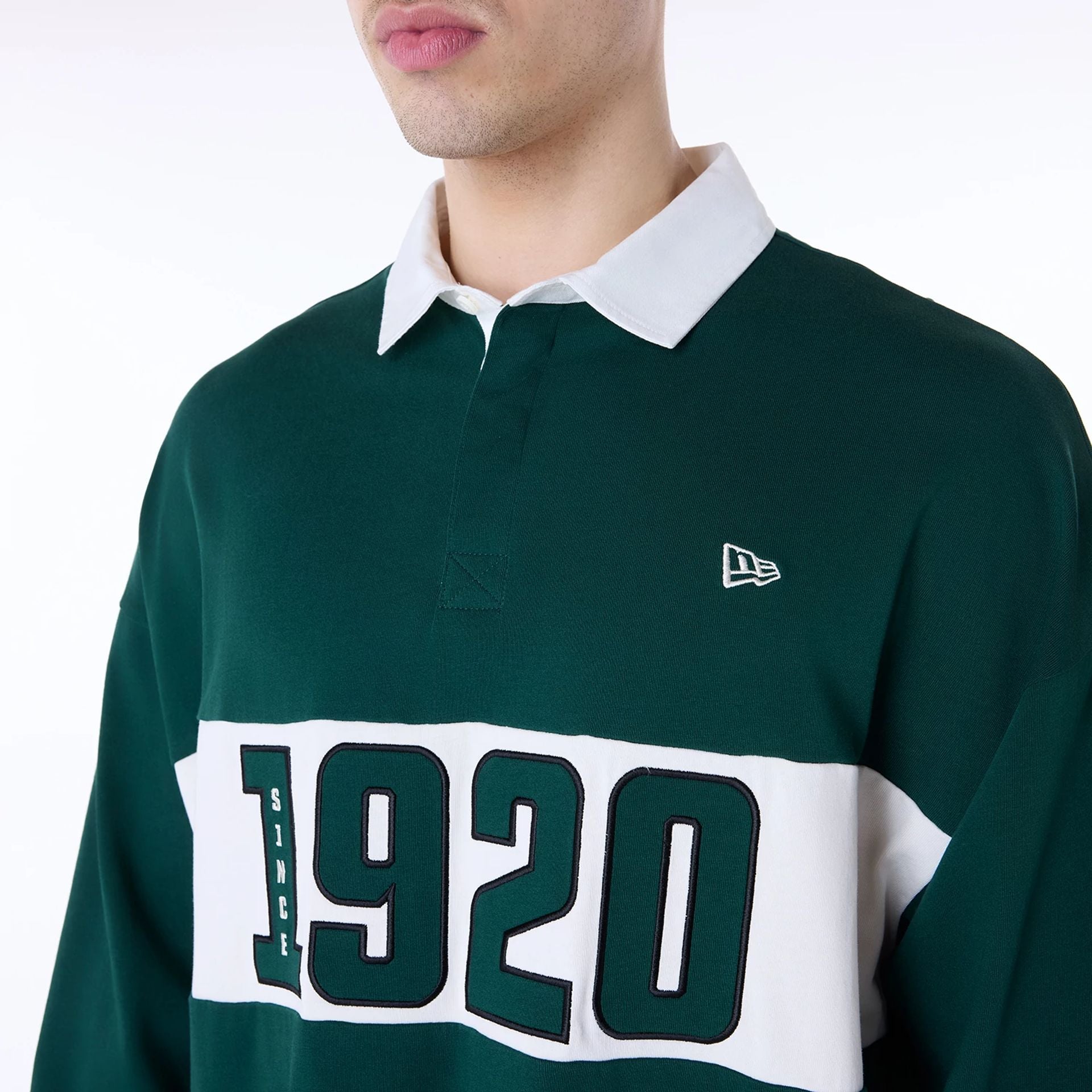 The Male model is wearing New Era Drop Shoulder Dark Green Rugby 6