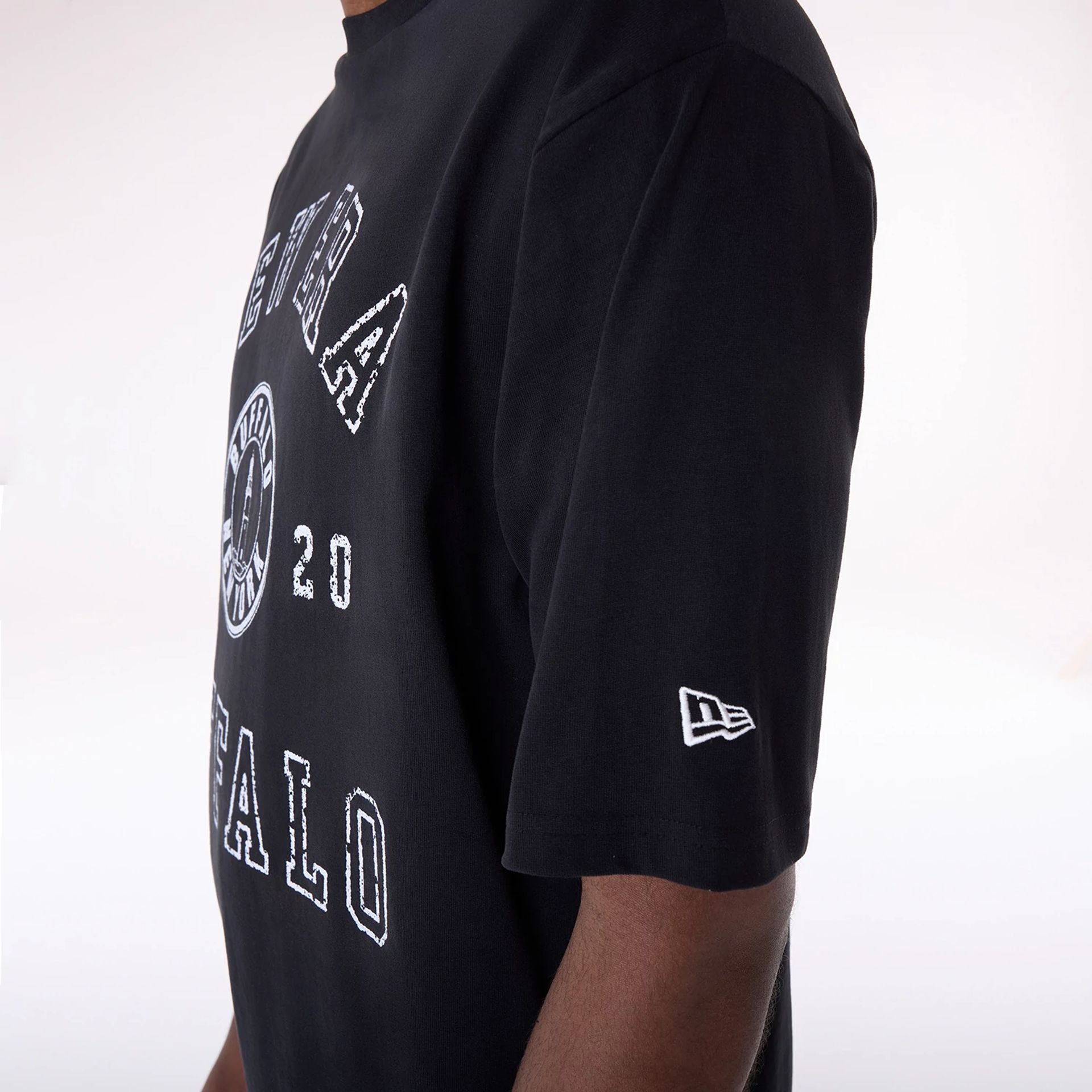 The Male model is wearing New Era Graphic Black Oversized T-Shirt 7