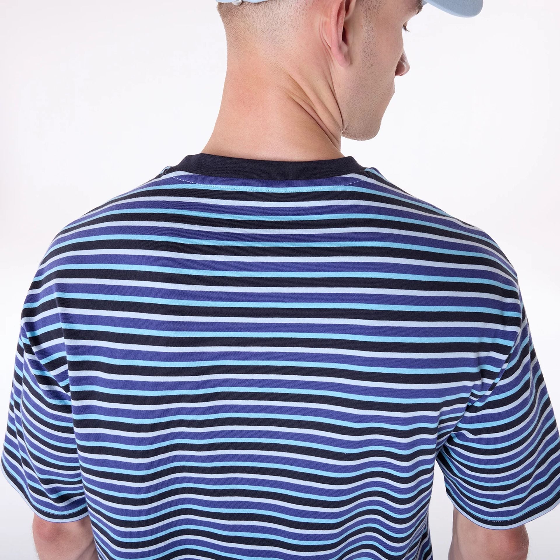 The Male model is wearing New Era Stripe Pastel Blue T-Shirt 6