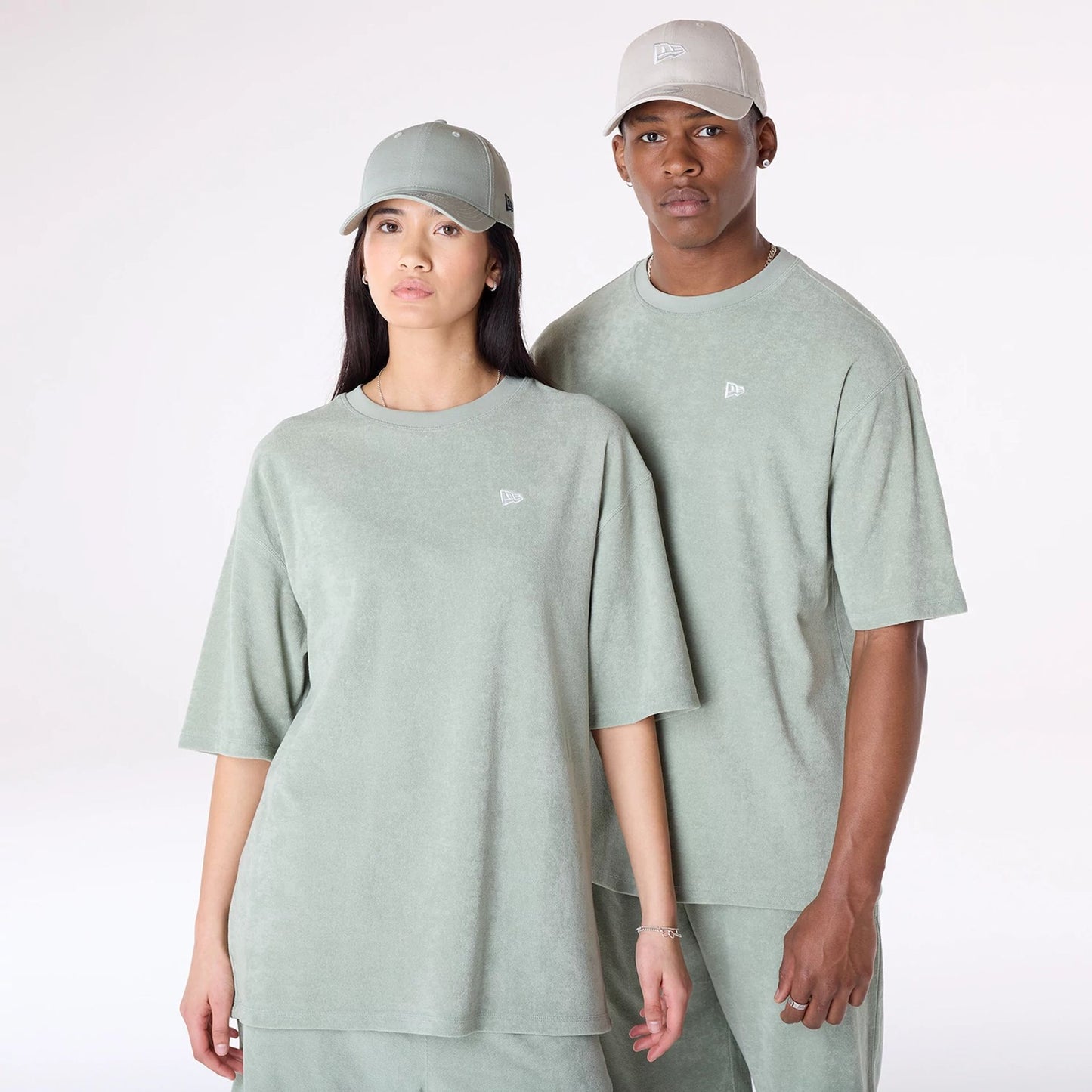 The Male model is wearing New Era Towelling Pastel Green Oversized T-Shirt 1