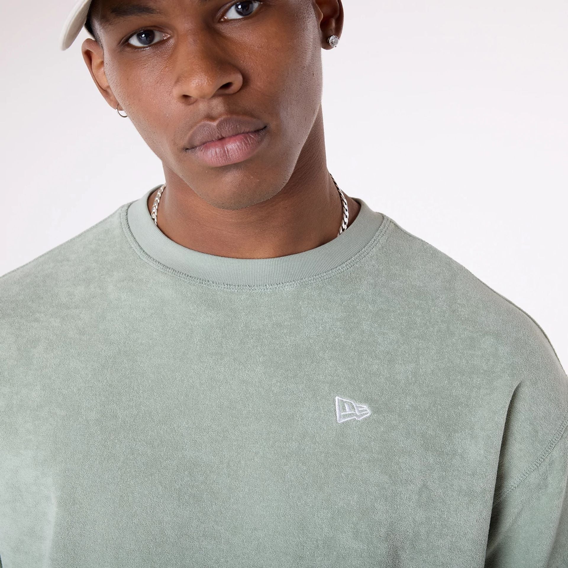 The Male model is wearing New Era Towelling Pastel Green Oversized T-Shirt 7