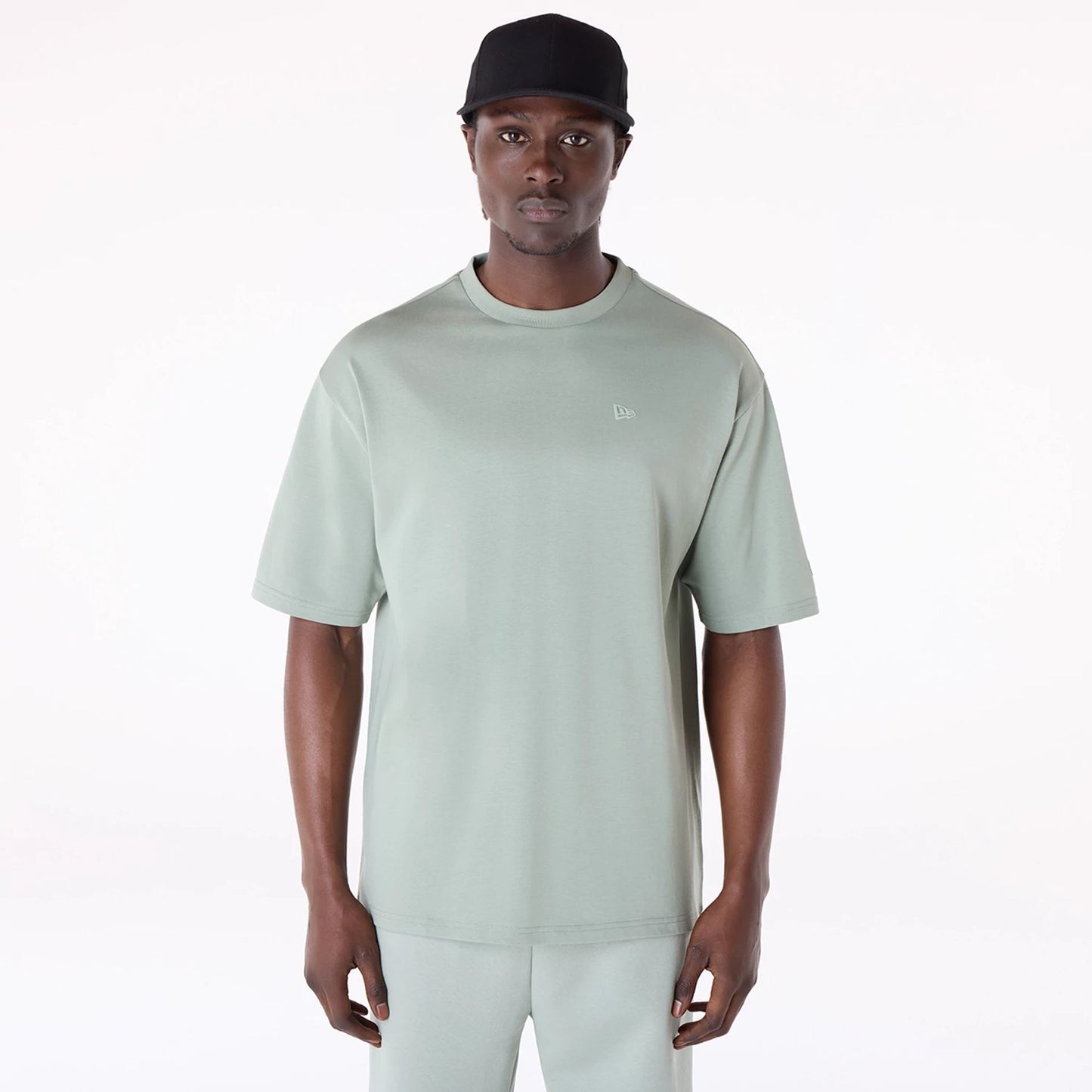 The Male model is wearing New Era Sticker Pastel Green Oversized T-Shirt 1