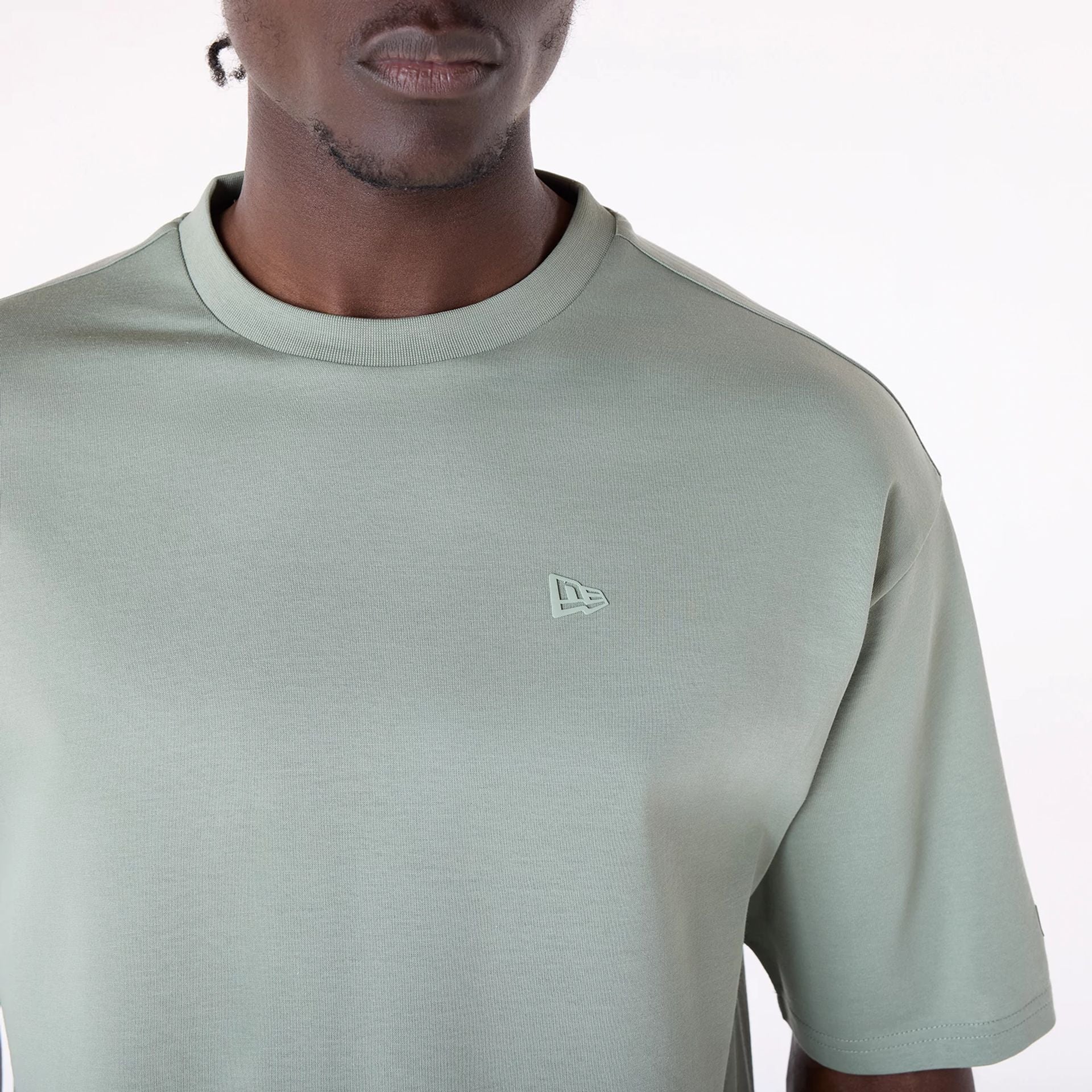 The Male model is wearing New Era Sticker Pastel Green Oversized T-Shirt 3