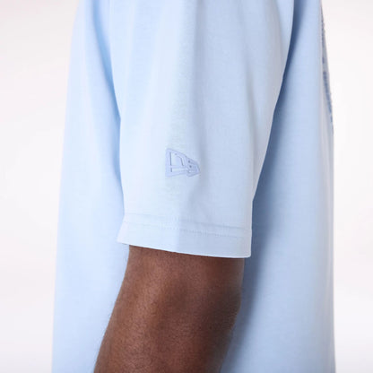 The Male model is wearing New Era Sticker Pastel Blue Oversized T-Shirt 6