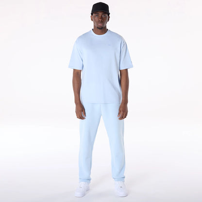 The Male model is wearing New Era Sticker Pastel Blue Oversized T-Shirt 5