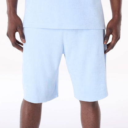 The Male model is wearing New Era Towelling Pastel Blue Shorts 8