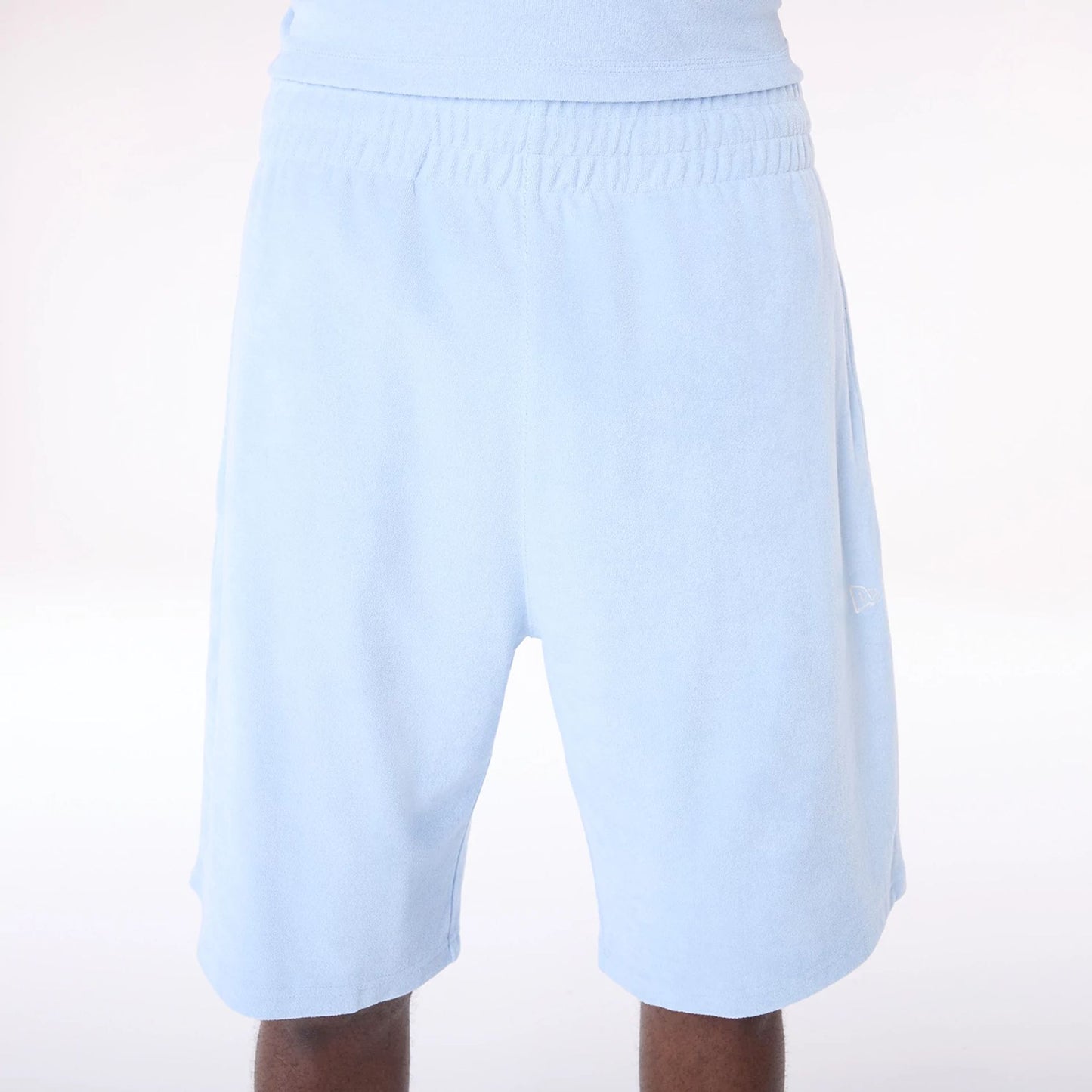 The Male model is wearing New Era Towelling Pastel Blue Shorts 3