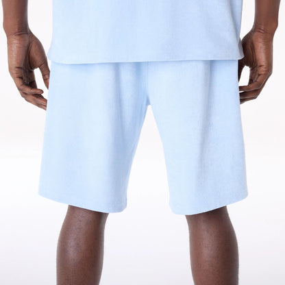 The Male model is wearing New Era Towelling Pastel Blue Shorts 2