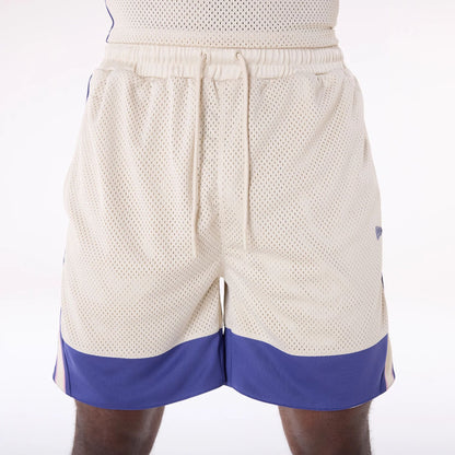 The Male model is wearing New Era Mesh Light Beige Oversized Shorts 3