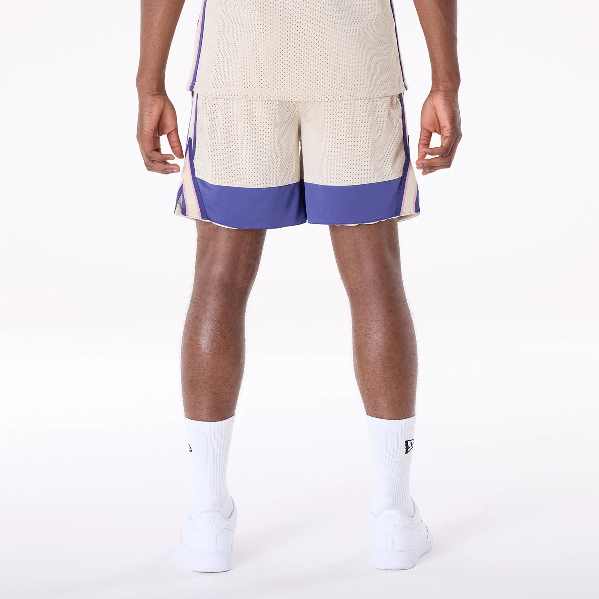 The Male model is wearing New Era Mesh Light Beige Oversized Shorts 4