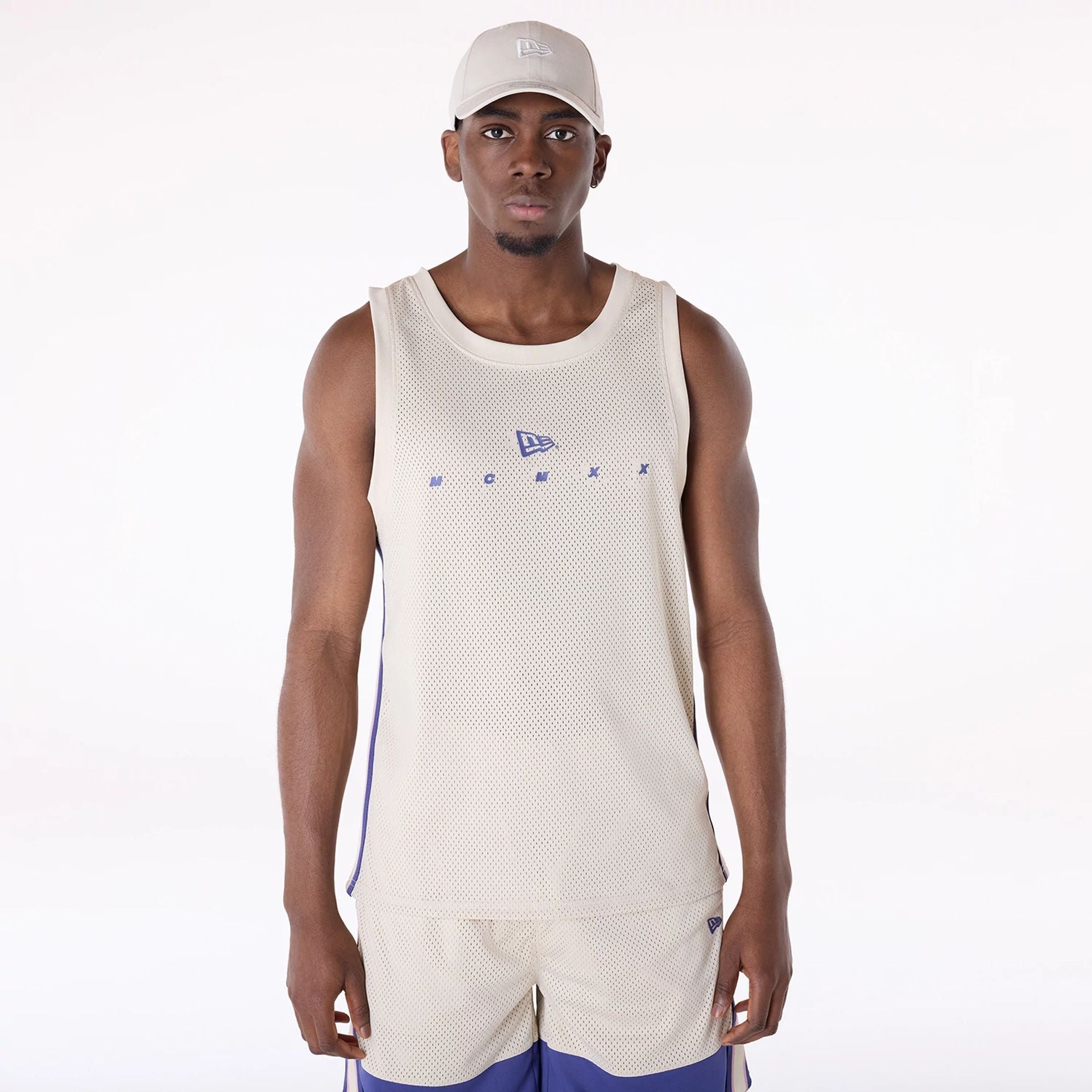 The Male model is wearing New Era Mesh Light Beige Vest 1