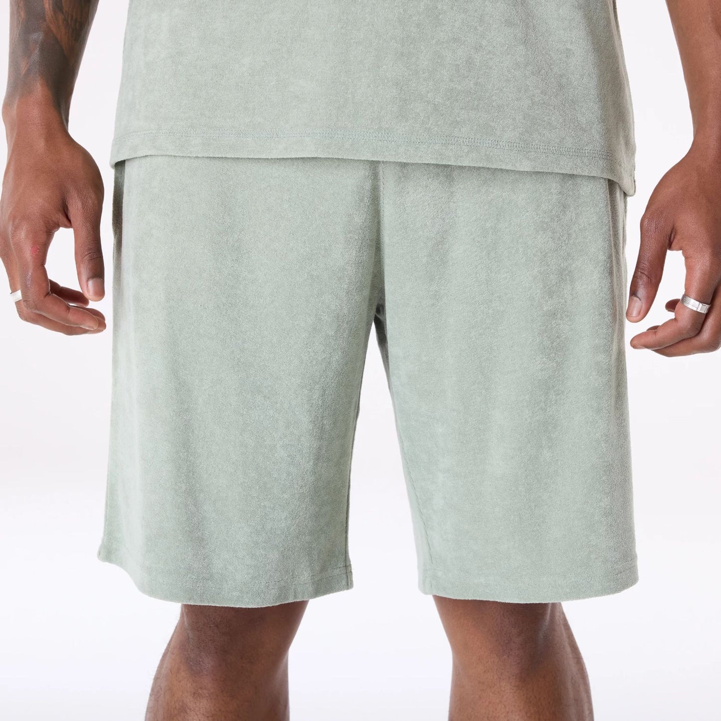 The Male model is wearing New Era Towelling Pastel Green Shorts 6