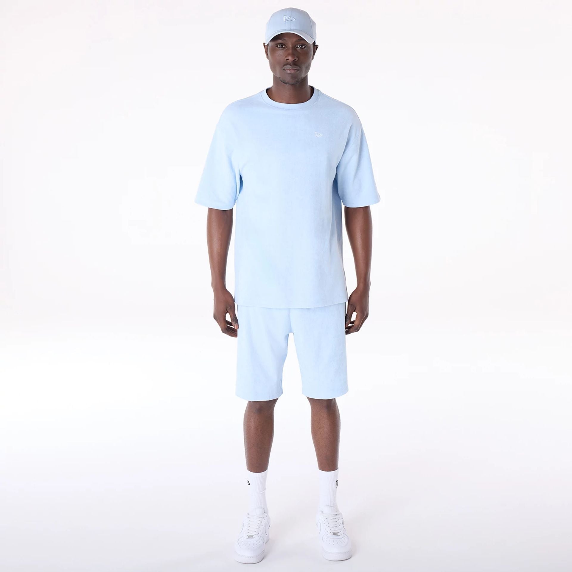 The Male model is wearing New Era Towelling Pastel Blue Oversized T-Shirt 5