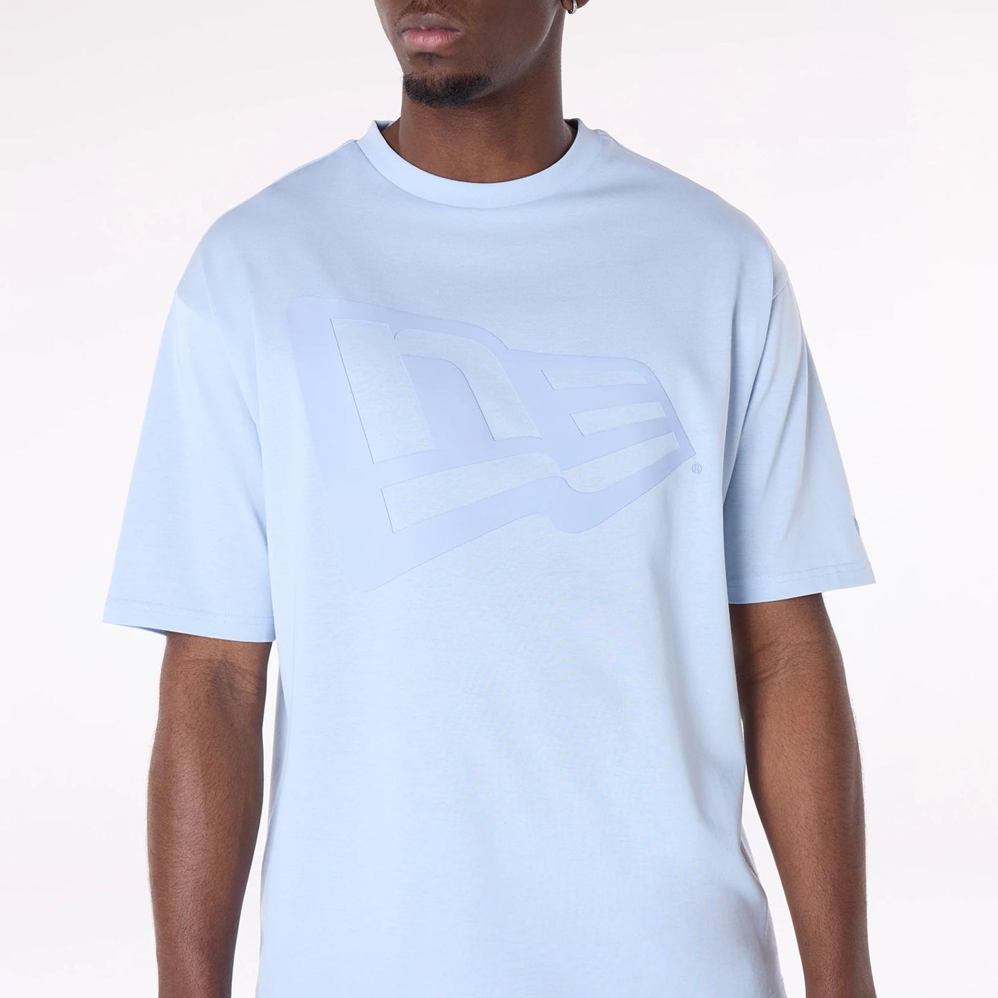 The Male model is wearing New Era Flag Pastel Blue Oversized T-Shirt 8